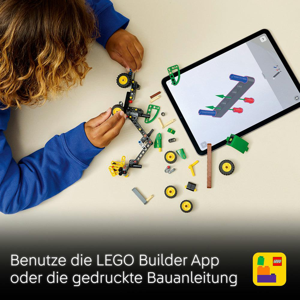 Kind baut mit LEGO und Tablet-Anleitung. Viele Teile liegen herum.