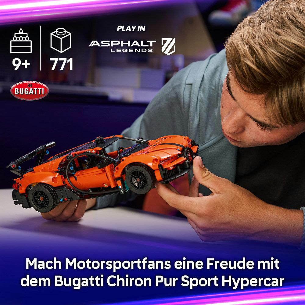 Ein Junge baut einen orangen Lego Bugatti Chiron.