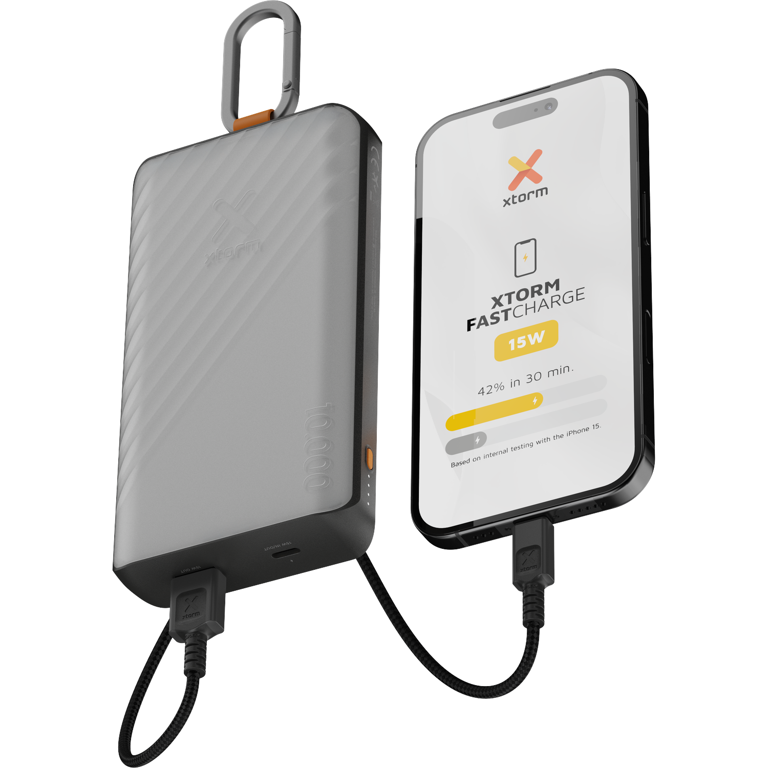 A gray Xtorm power bank with carabiner and an iPhone being charged.