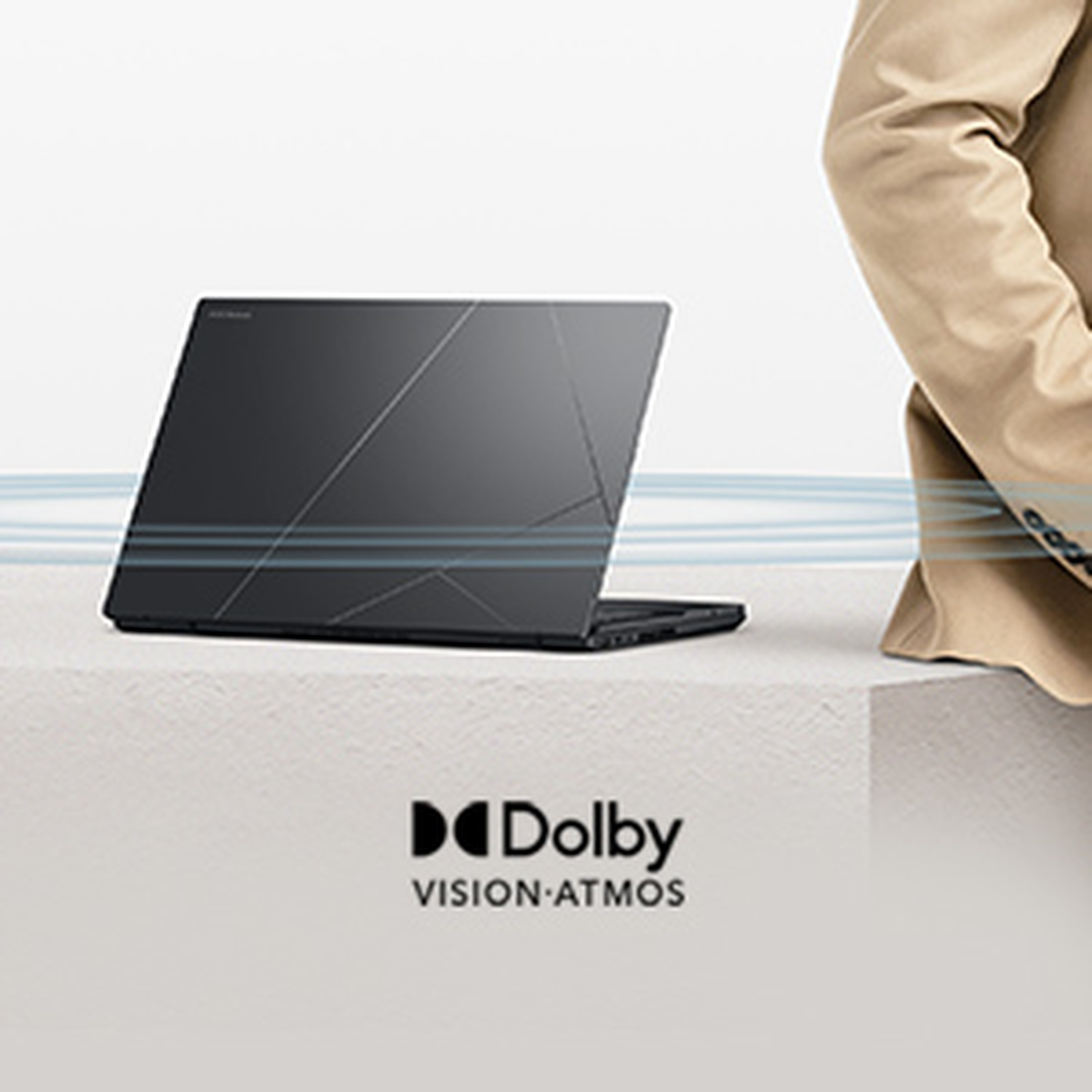 Black laptop on white pedestal with Dolby Vision Atmos logo.
