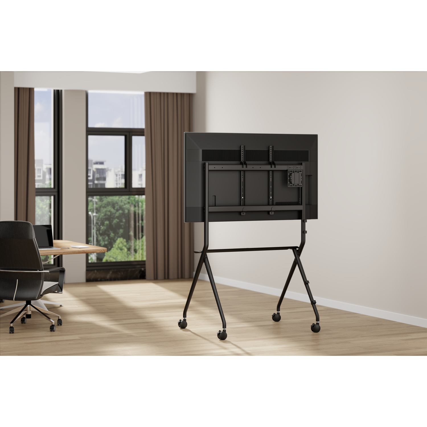 Een zwarte televisie op een rolstandaard in een kantoor met houten vloer.