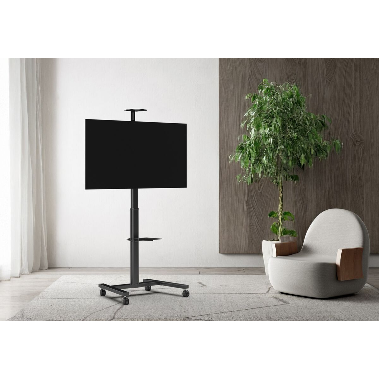 A black TV stand on wheels sits in front of a light wall and an armchair.