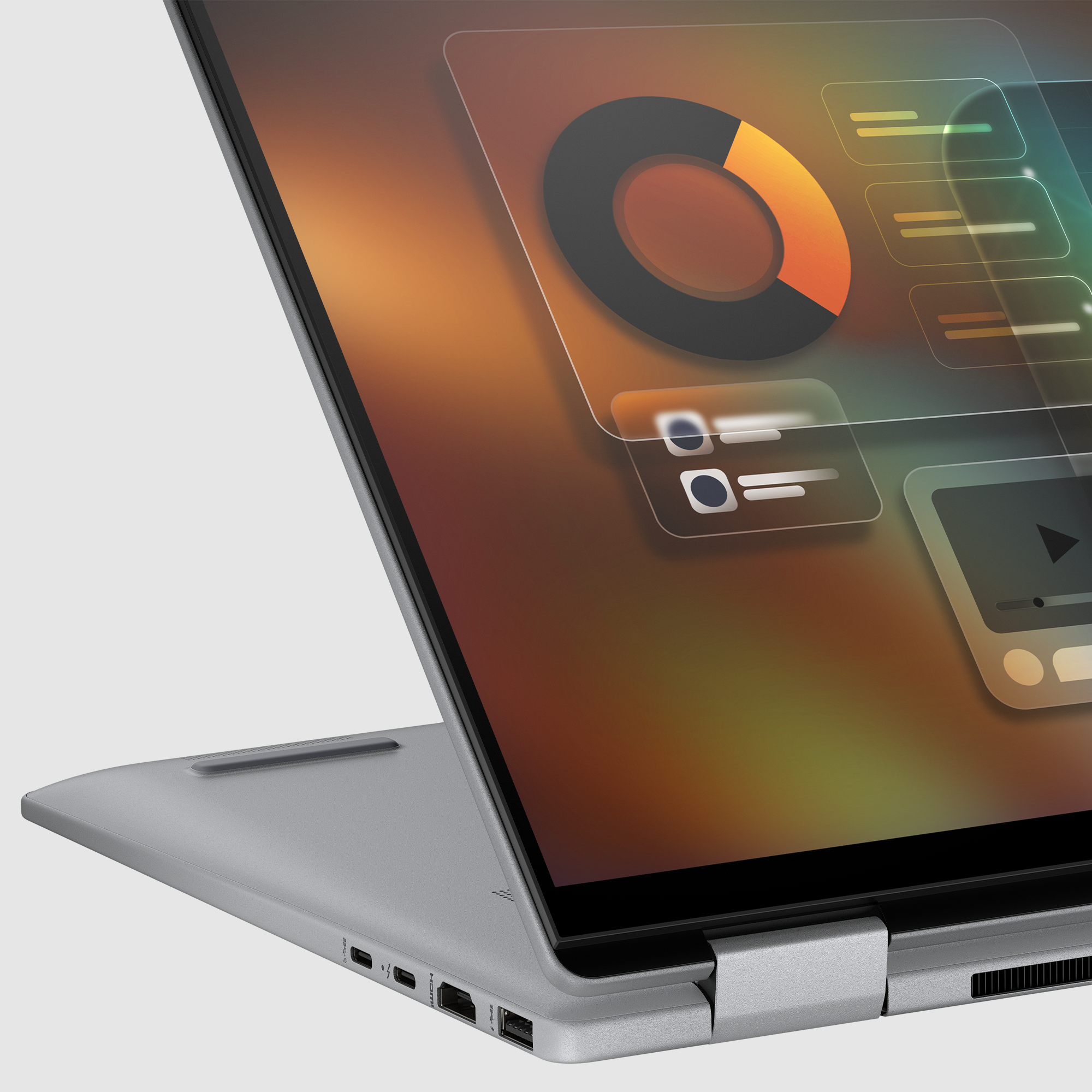 Srebrny laptop wyświetlający na ekranie wykres kołowy i ikony.