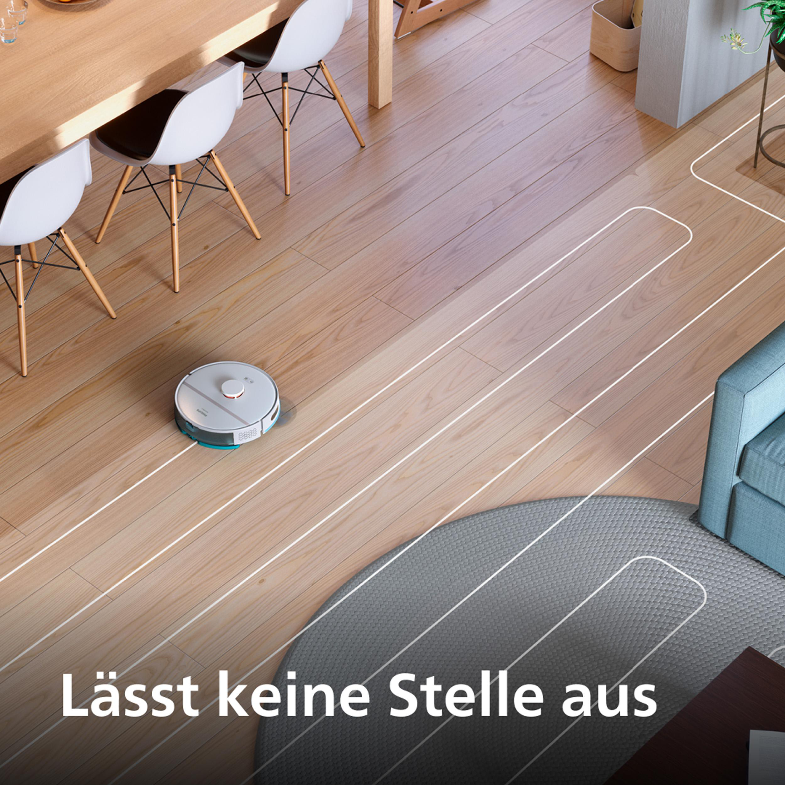 Ein weißer Saugroboter auf einem hellen Holzboden, mit weißen Linien, die seinen Reinigungsweg um Möbel herum zeigen.