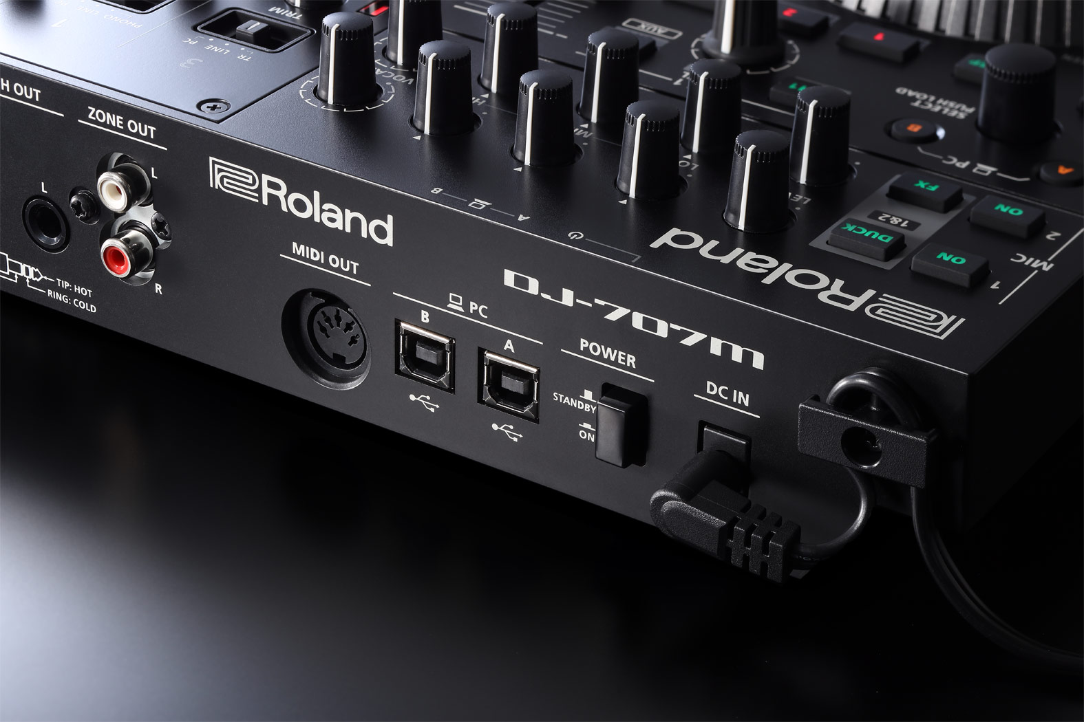 Schwarzer DJ-Controller mit Reglern, Knöpfen, Anschlüssen und Beschriftungen.