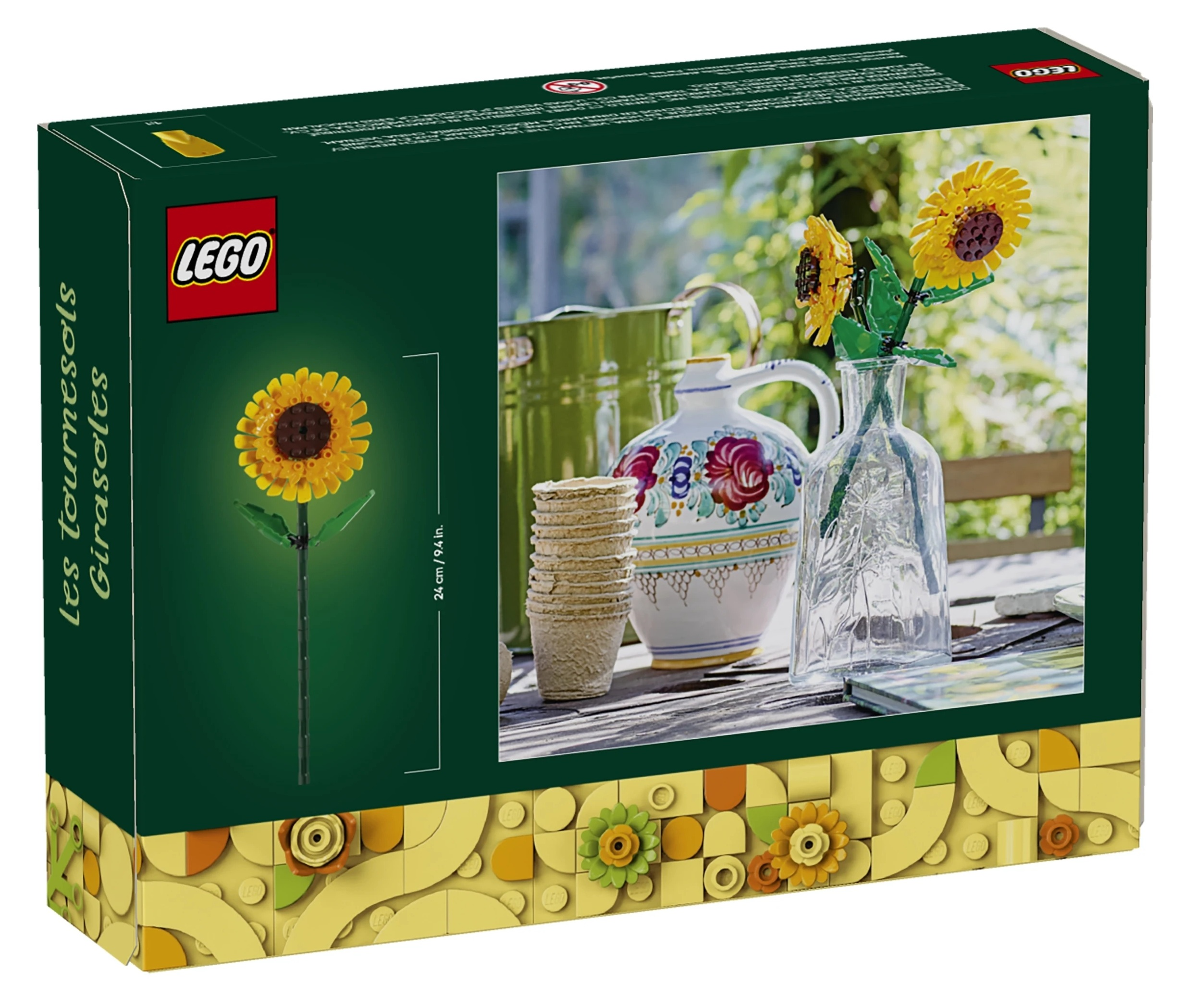 Zestaw LEGO słoneczników z wazonem, konewką i doniczkami na stole.