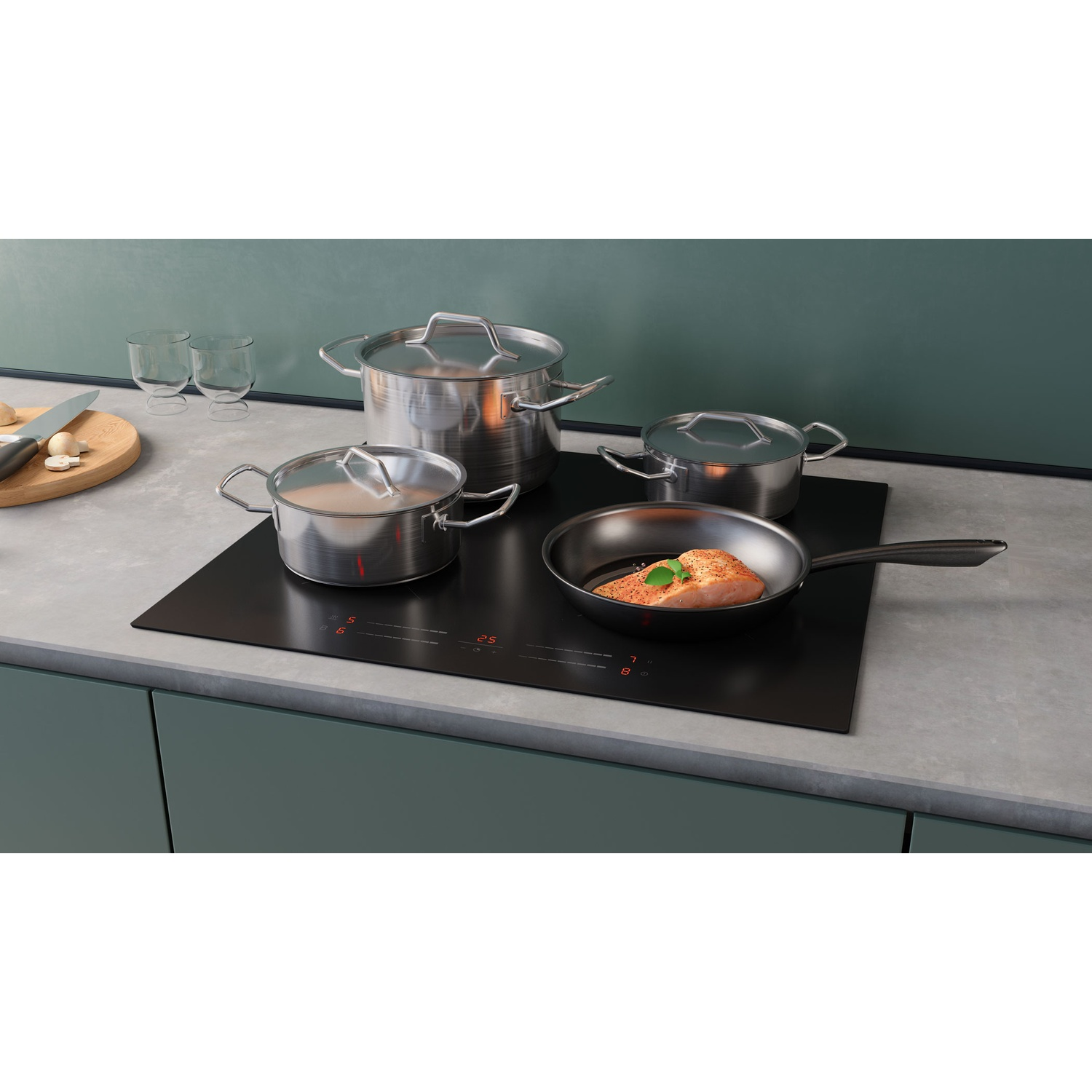 Un filet de poisson frit dans une poêle sur une plaque à induction avec des casseroles.