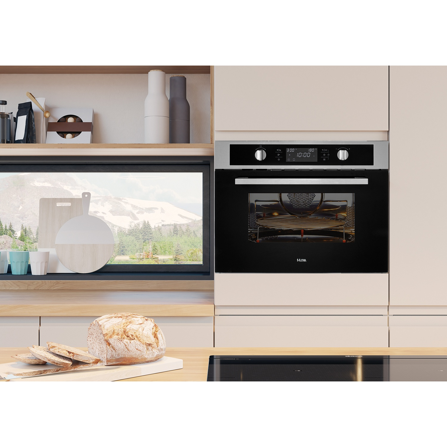 Modern kitchen with oven, bread, and mountain view through window.
