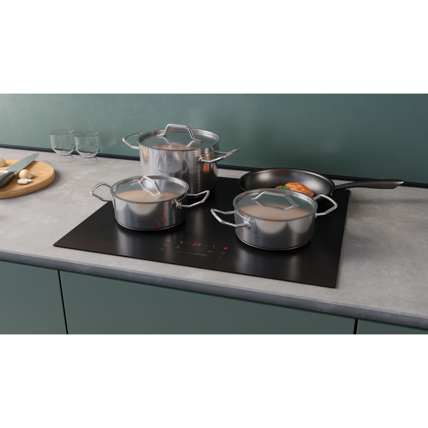 Stainless steel pots and pan on black stovetop with digital displays.