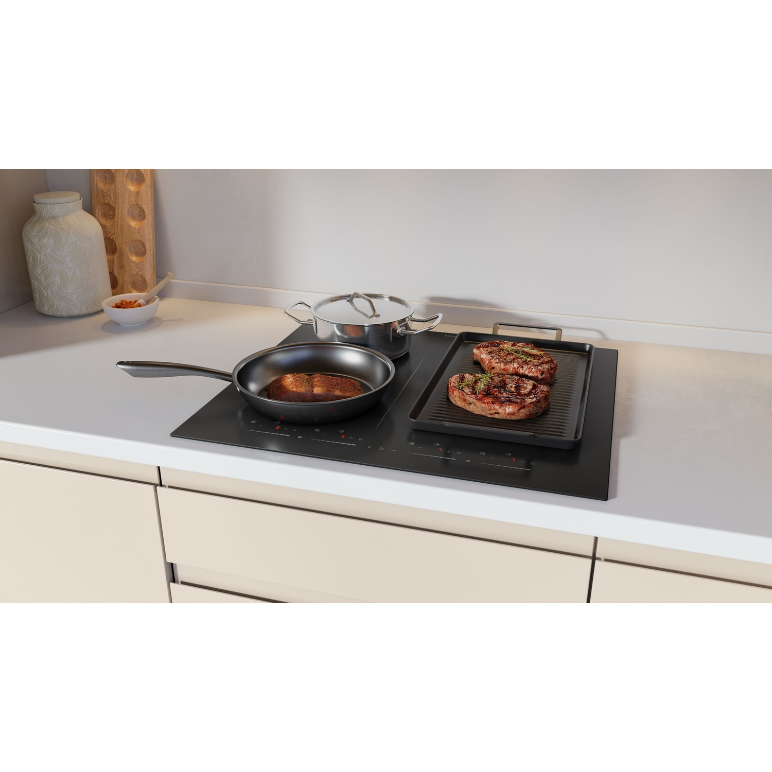 Two steaks on a grill pan and a pot on an induction cooktop.