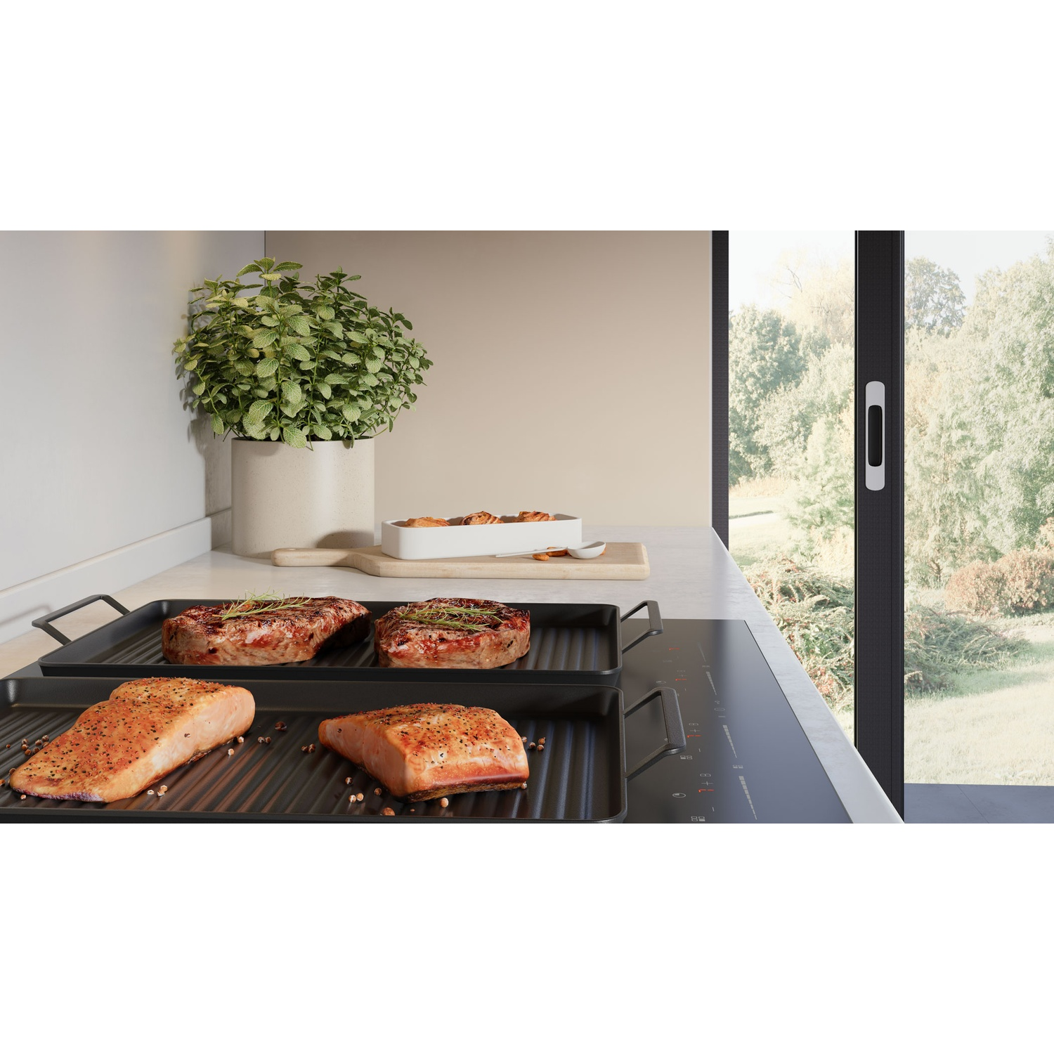 Two salmon fillets and two steaks are grilling on a modern induction hob.