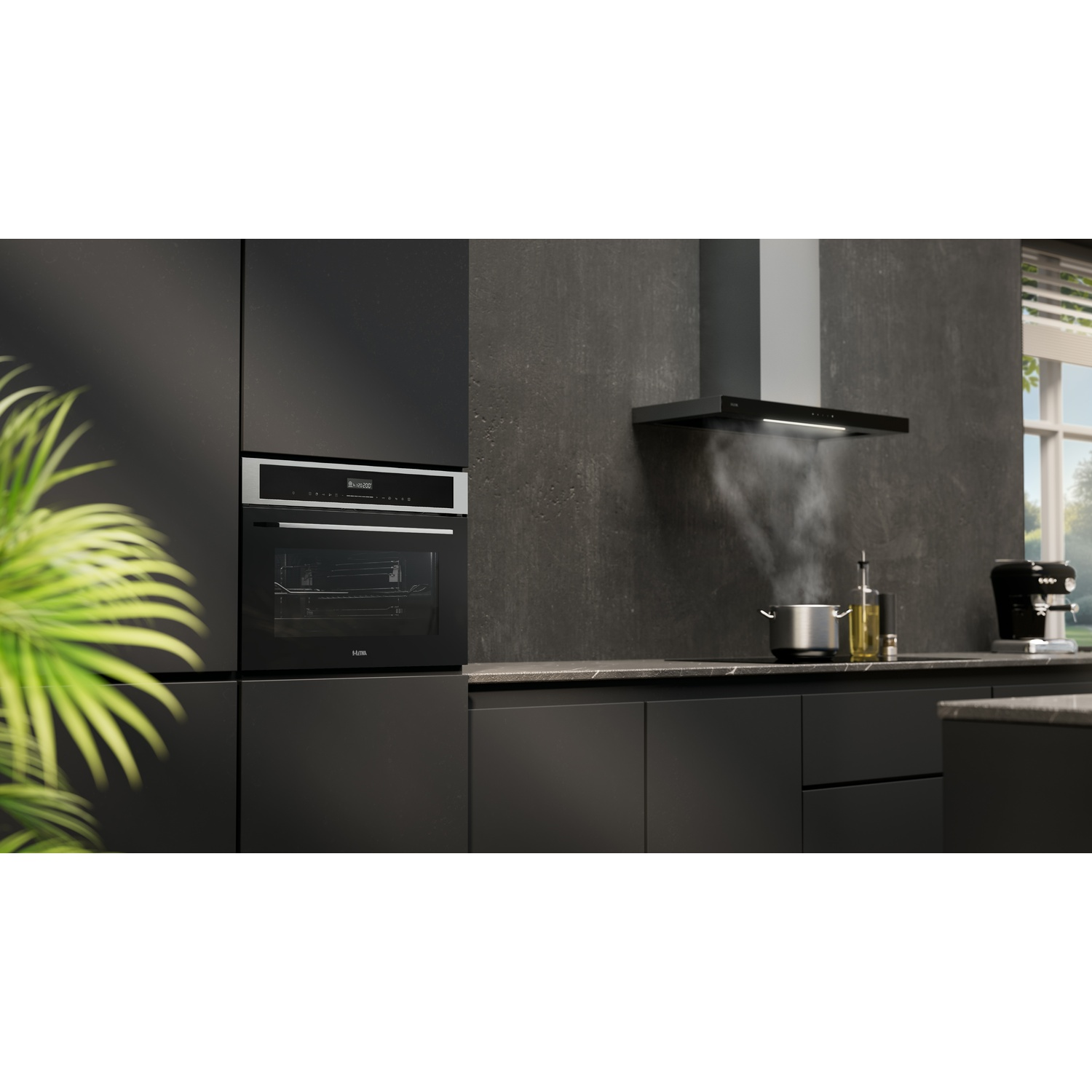 A modern black kitchen featuring an oven, and a range hood over a pot.
