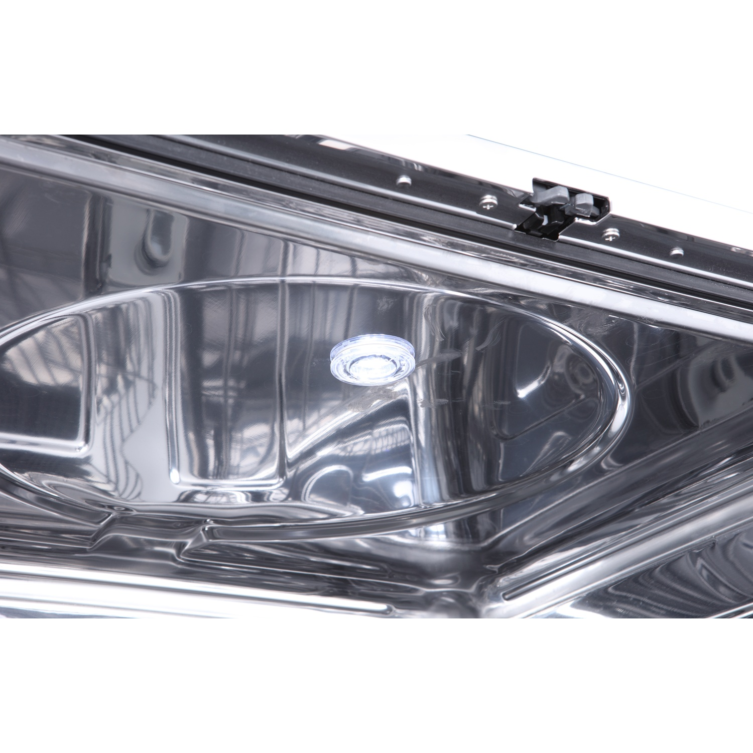 Stainless steel interior of a dishwasher with a small LED light.