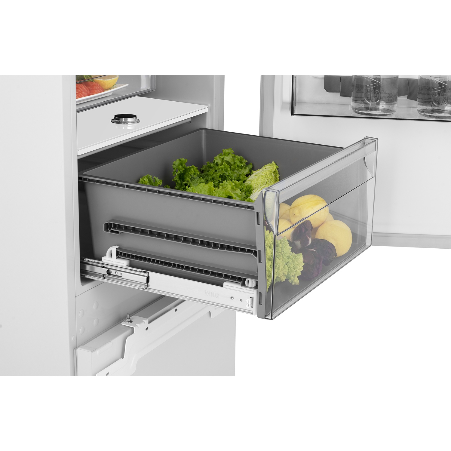 Open refrigerator drawer with lettuce and lemons inside.