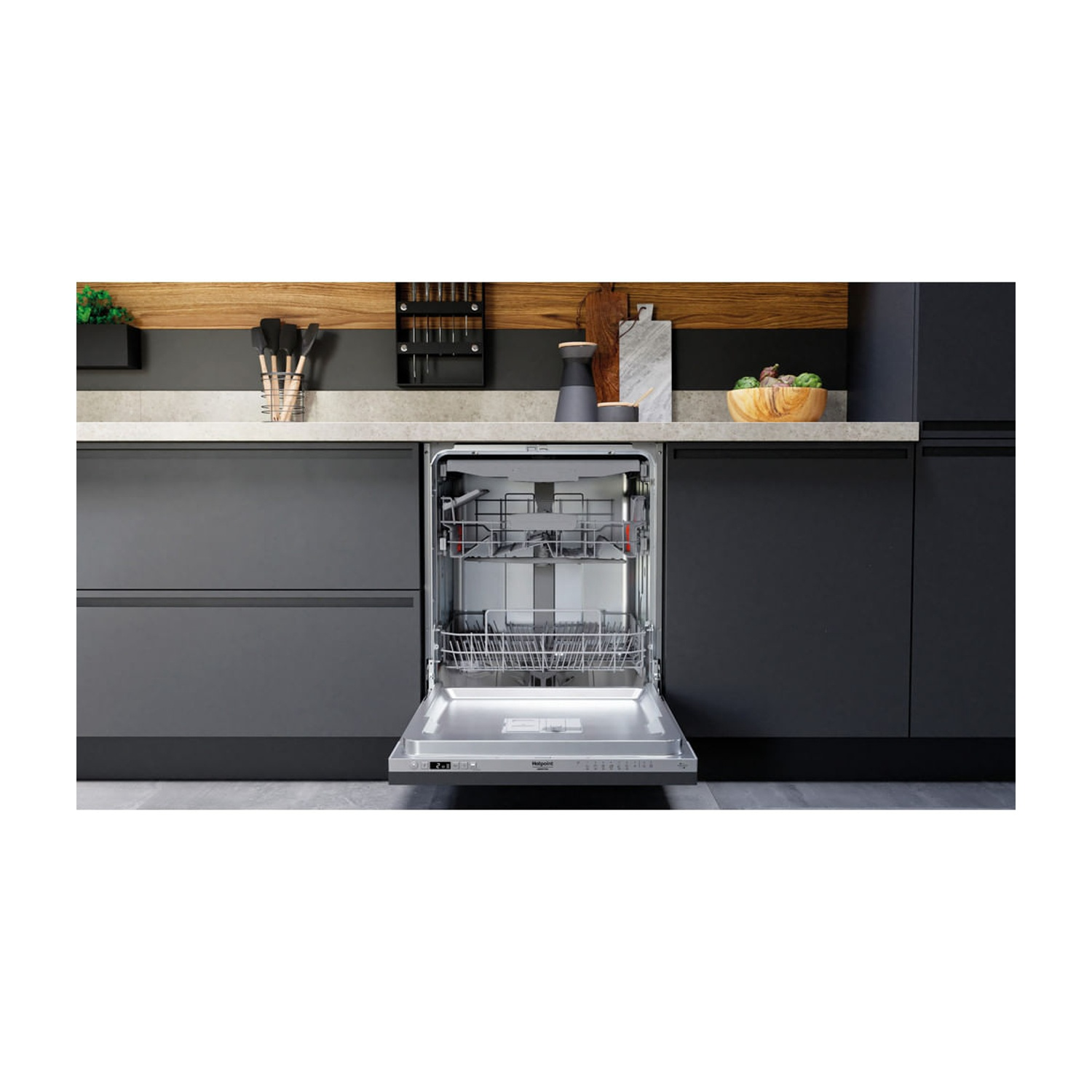 Una lavastoviglie aperta in una cucina moderna con mobili scuri.