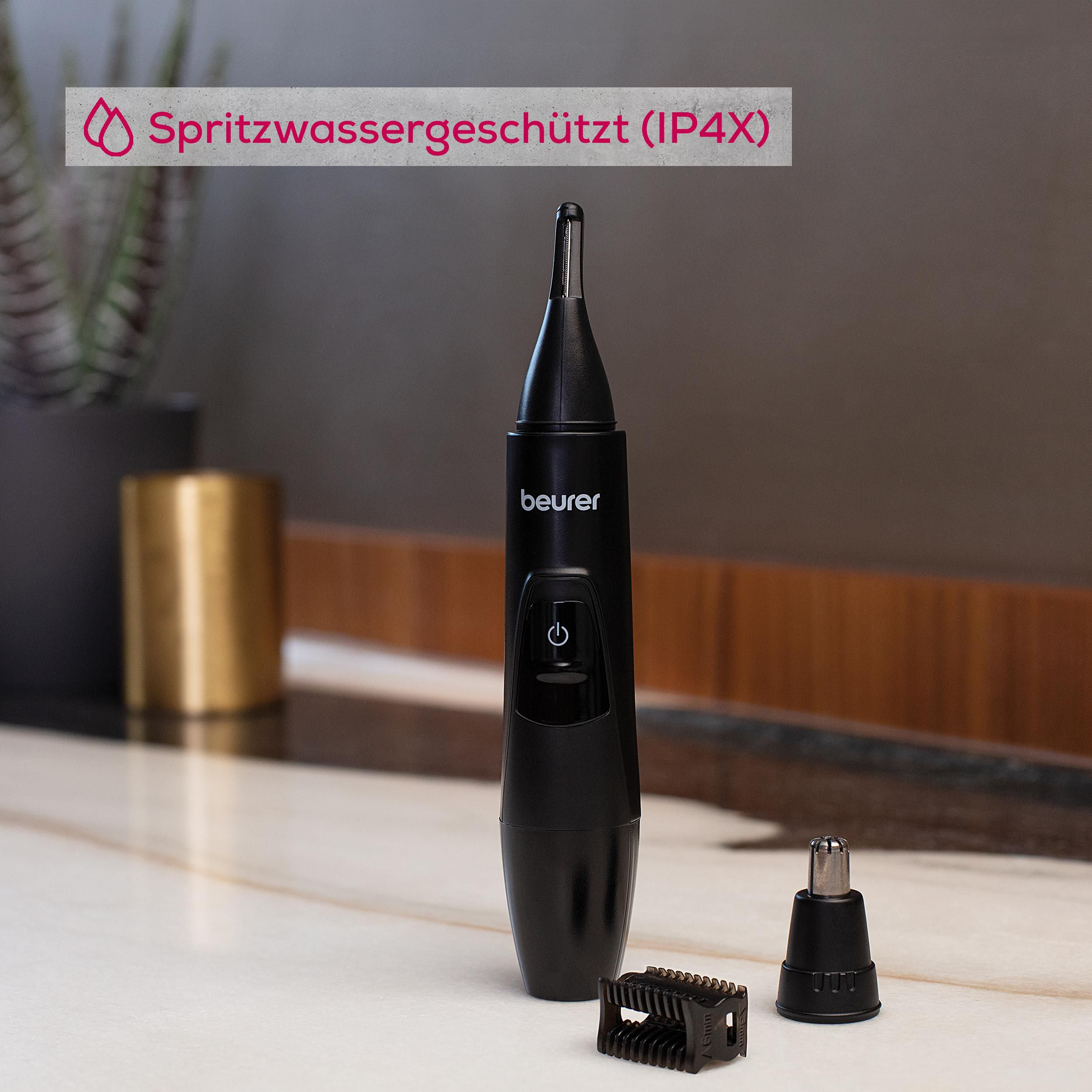 Schwarzer Beurer Nasenhaartrimmer mit Zubehör auf Marmortisch. Spritzwassergeschützt.