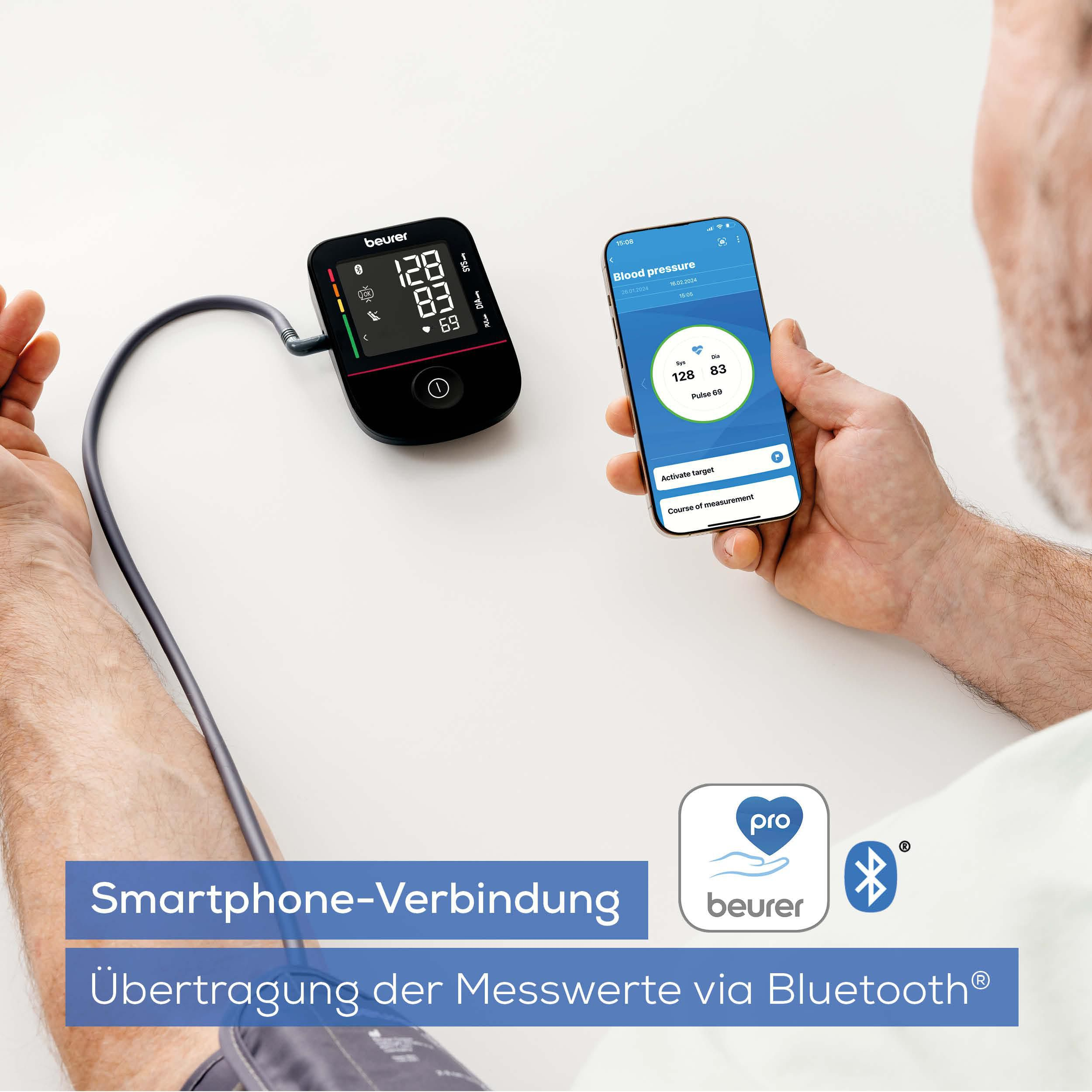 Ein Beurer Blutdruckmessgerät neben einem Smartphone, das Ergebnisse anzeigt.