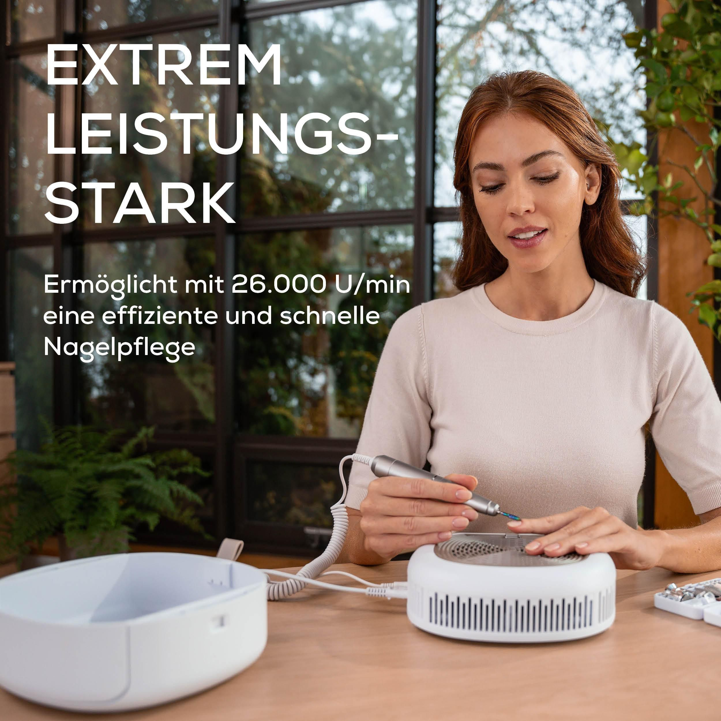 Eine Frau benutzt einen elektrischen Nagelfräser vor einem weißen Gerät.