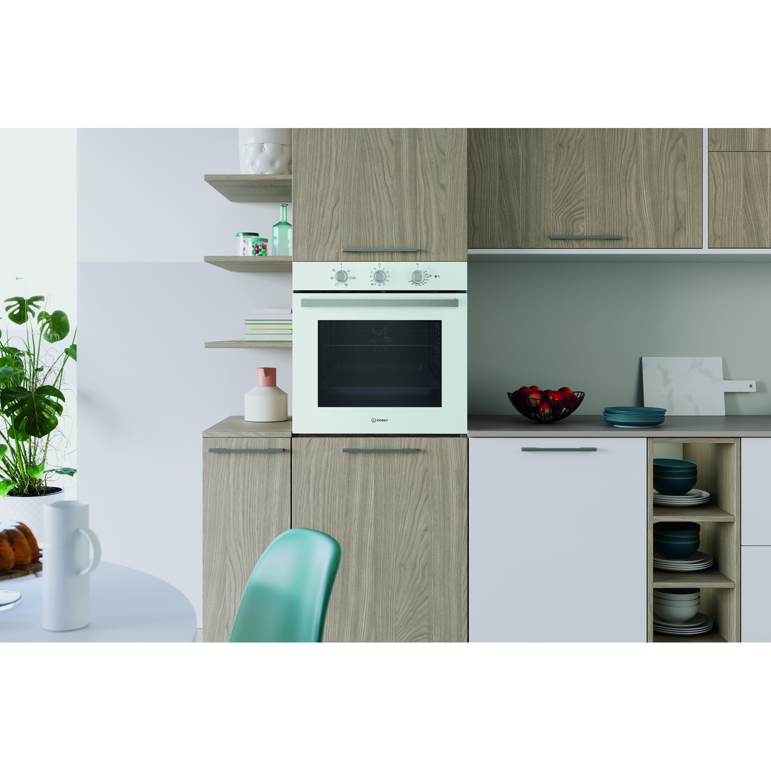 Cucina moderna con forno chiaro, elementi in legno e accenti verdi.