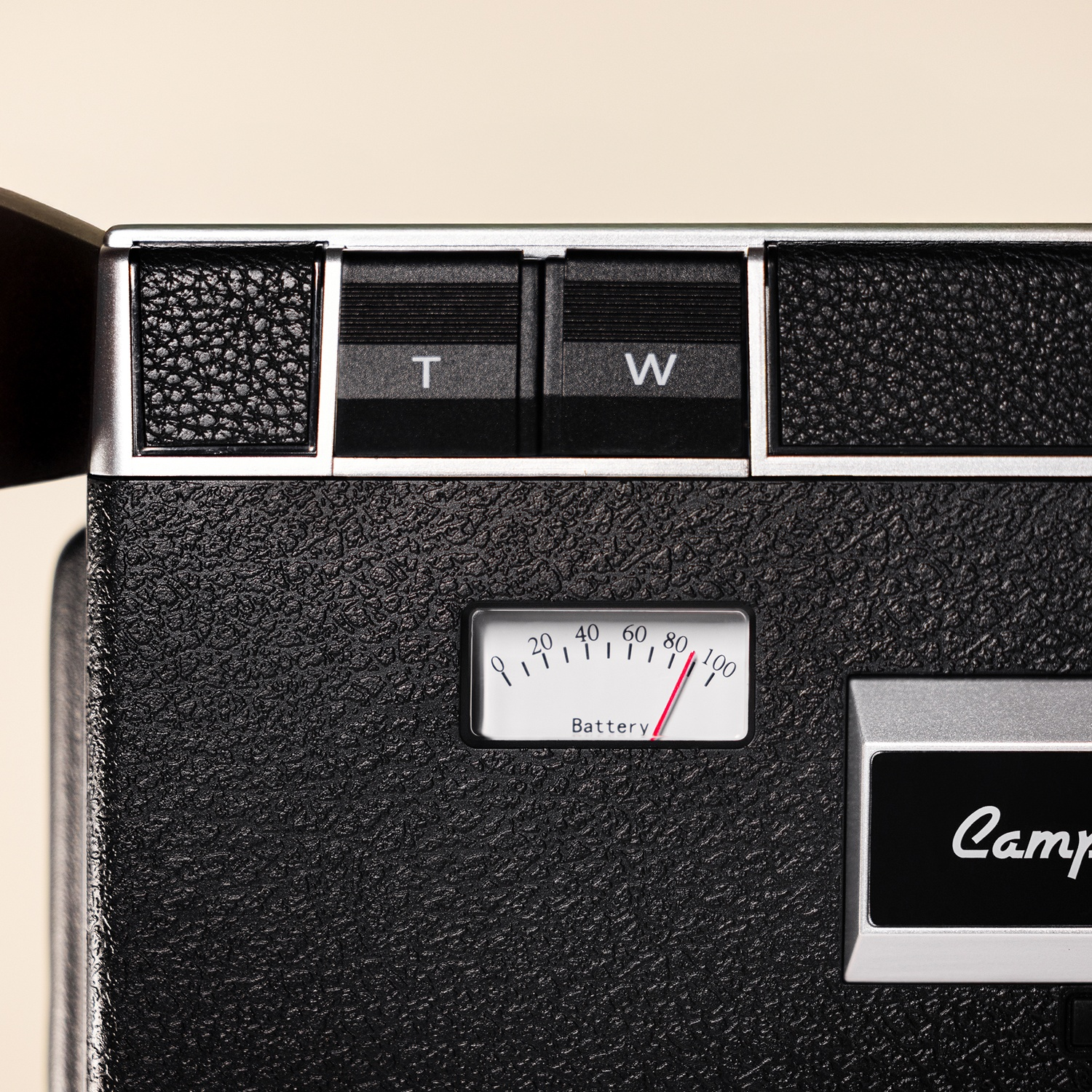 Close-up of a black camera with T and W buttons and a battery indicator.