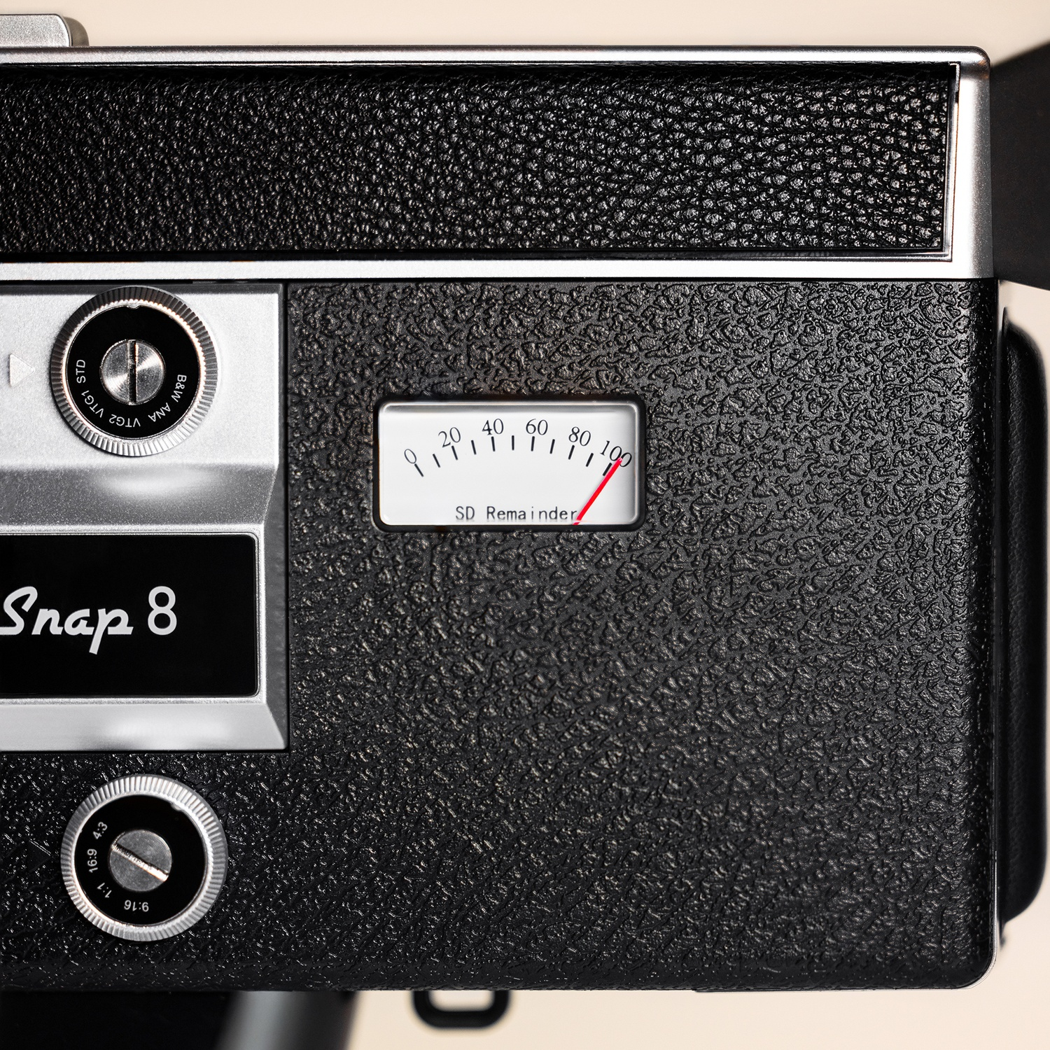 Close-up of a black camera with 'Snap 8' logo and a gauge.