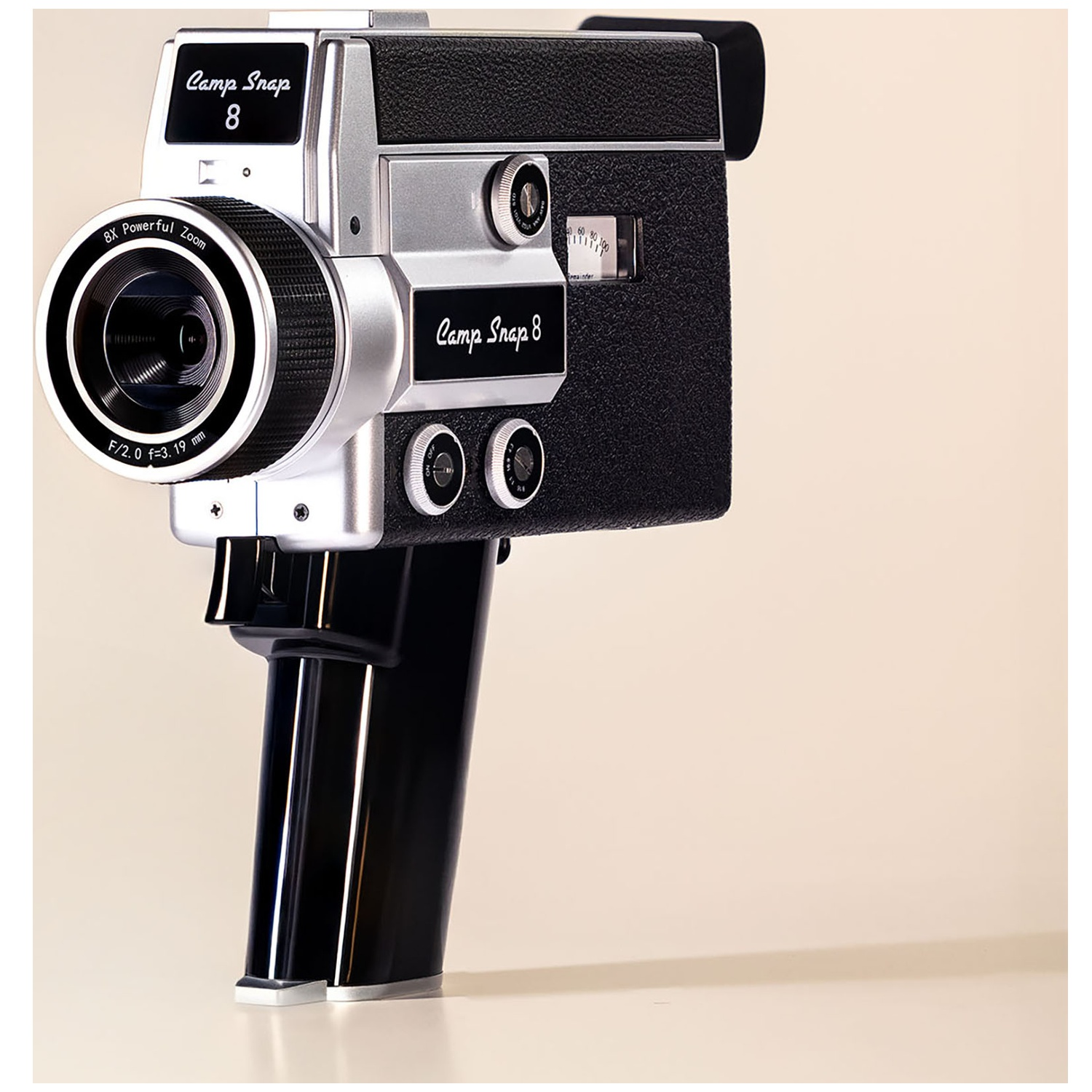 Vintage silver "Camp Snap 8" camcorder with a black grip and lens.