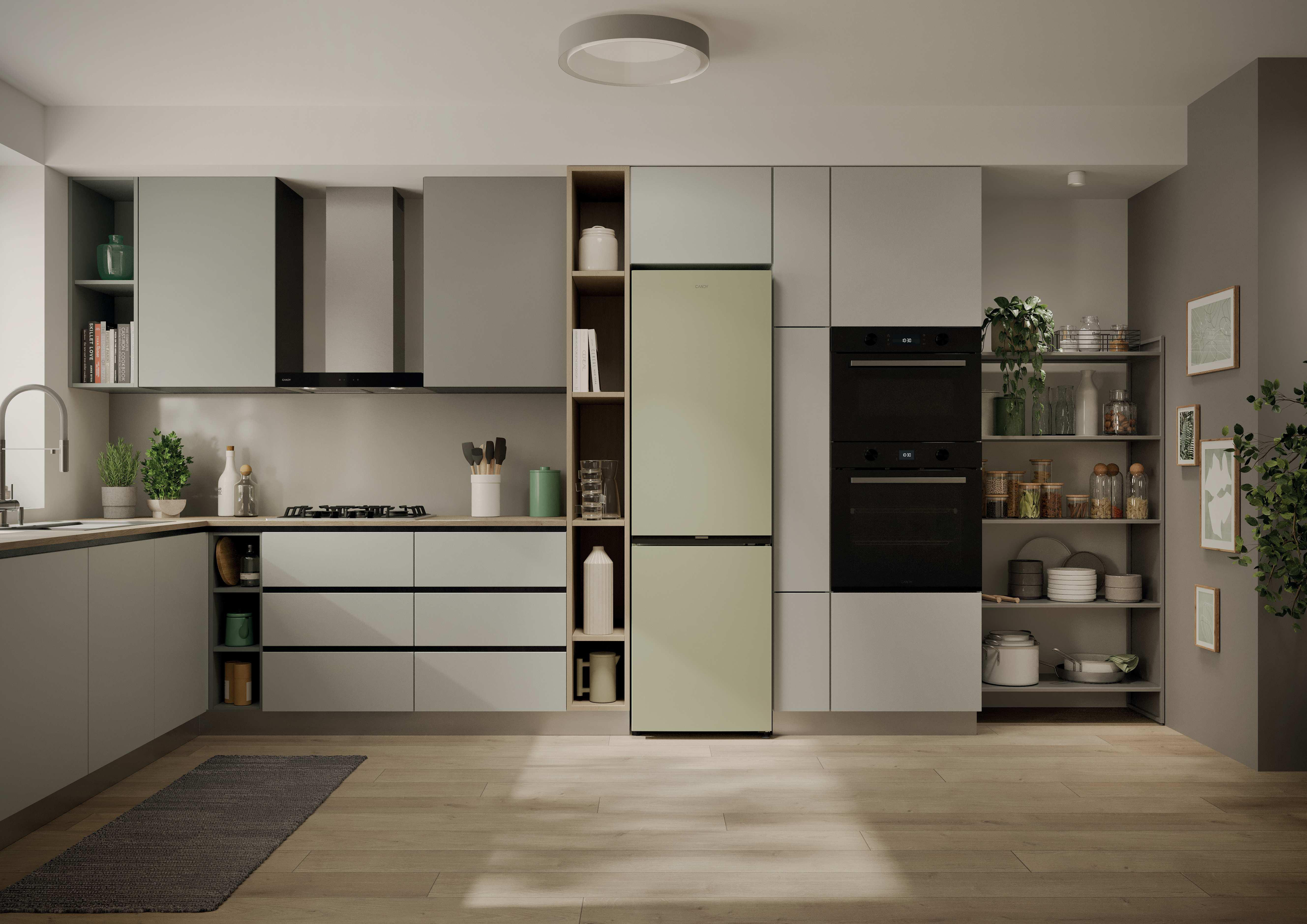 Moderne Küche mit hellgrünem Kühlschrank, schwarzen Öfen und Holzfußboden.