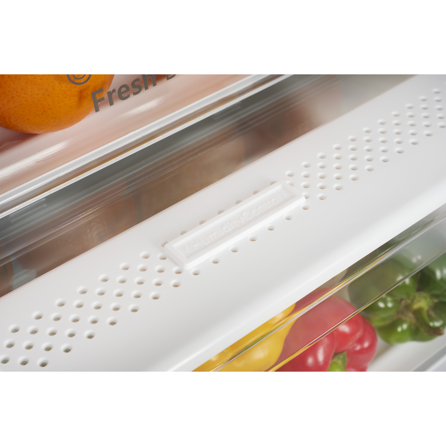 A drawer with an orange and vegetables, featuring humidity control.