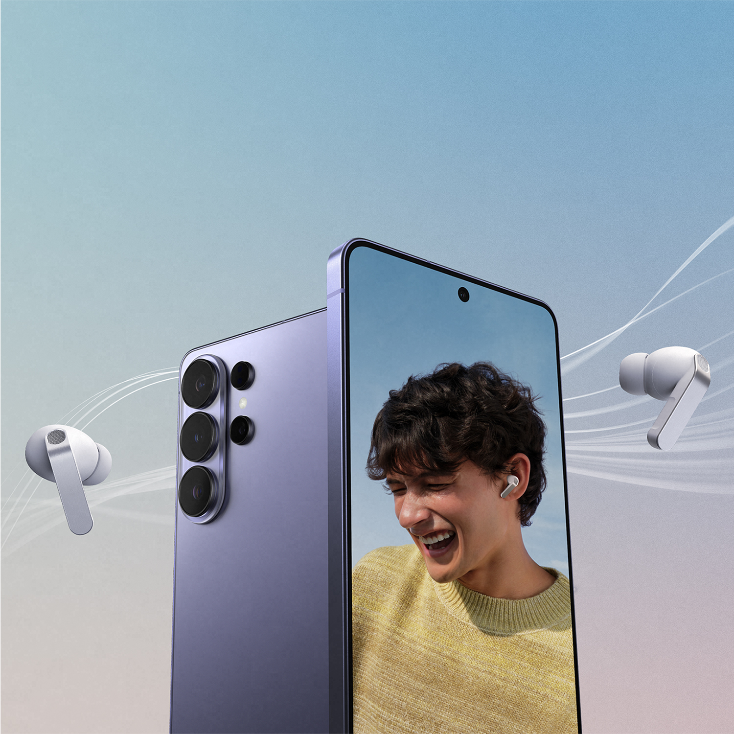 Hombre riendo, con auriculares. Teléfono y auriculares a su lado.