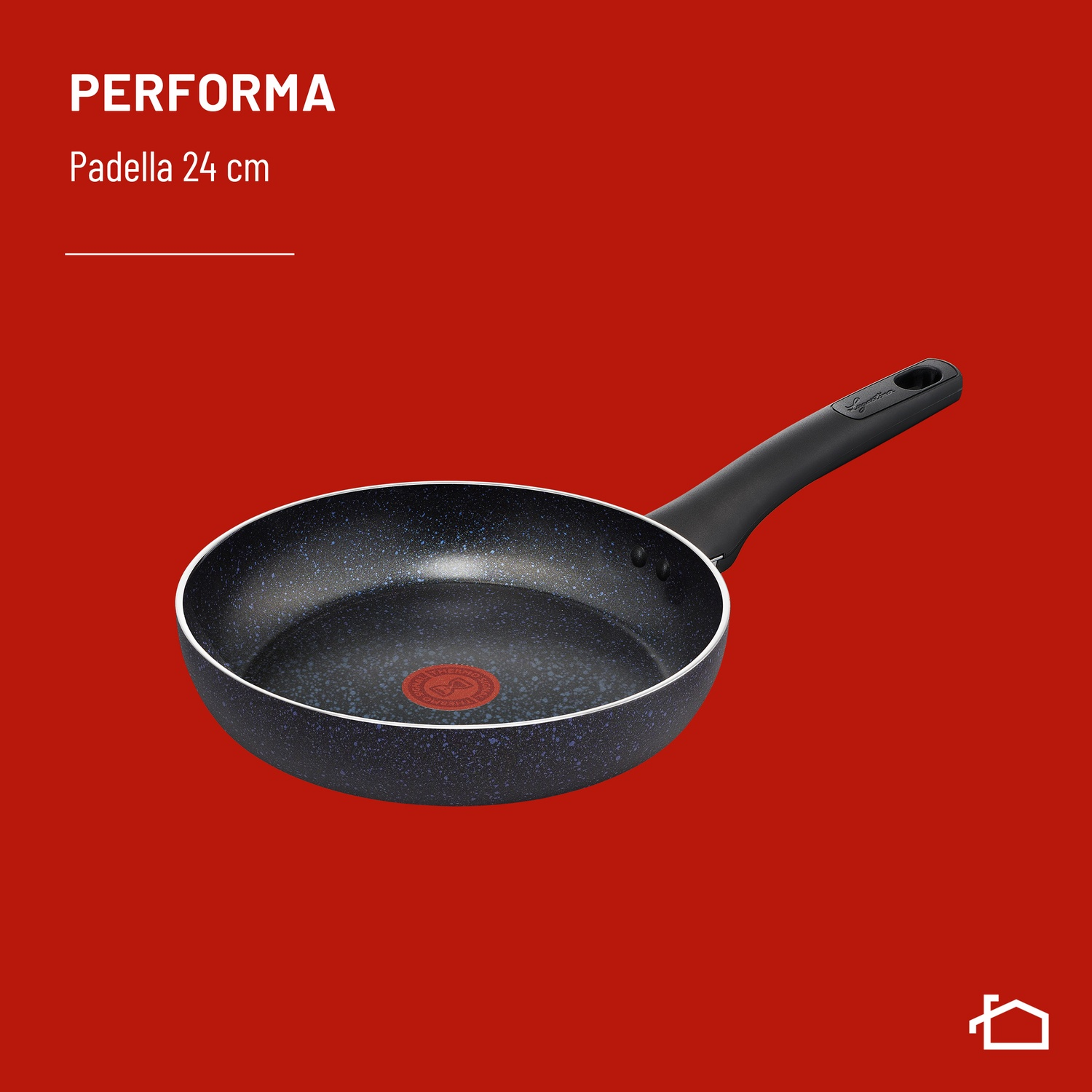 Una padella nera effetto granito con termospot rosso su sfondo rosso.