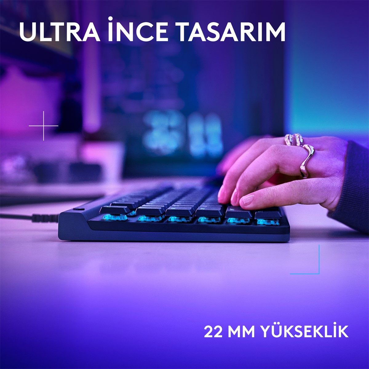 Mavi arka aydınlatmalı ince klavyede bir el yazıyor. Ultra ince tasarım.