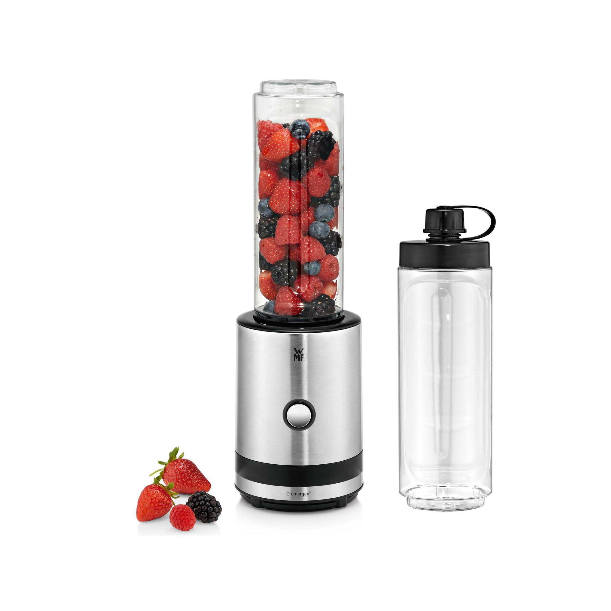 Ein Smoothie-Mixer mit Beeren und einem leeren Behälter.