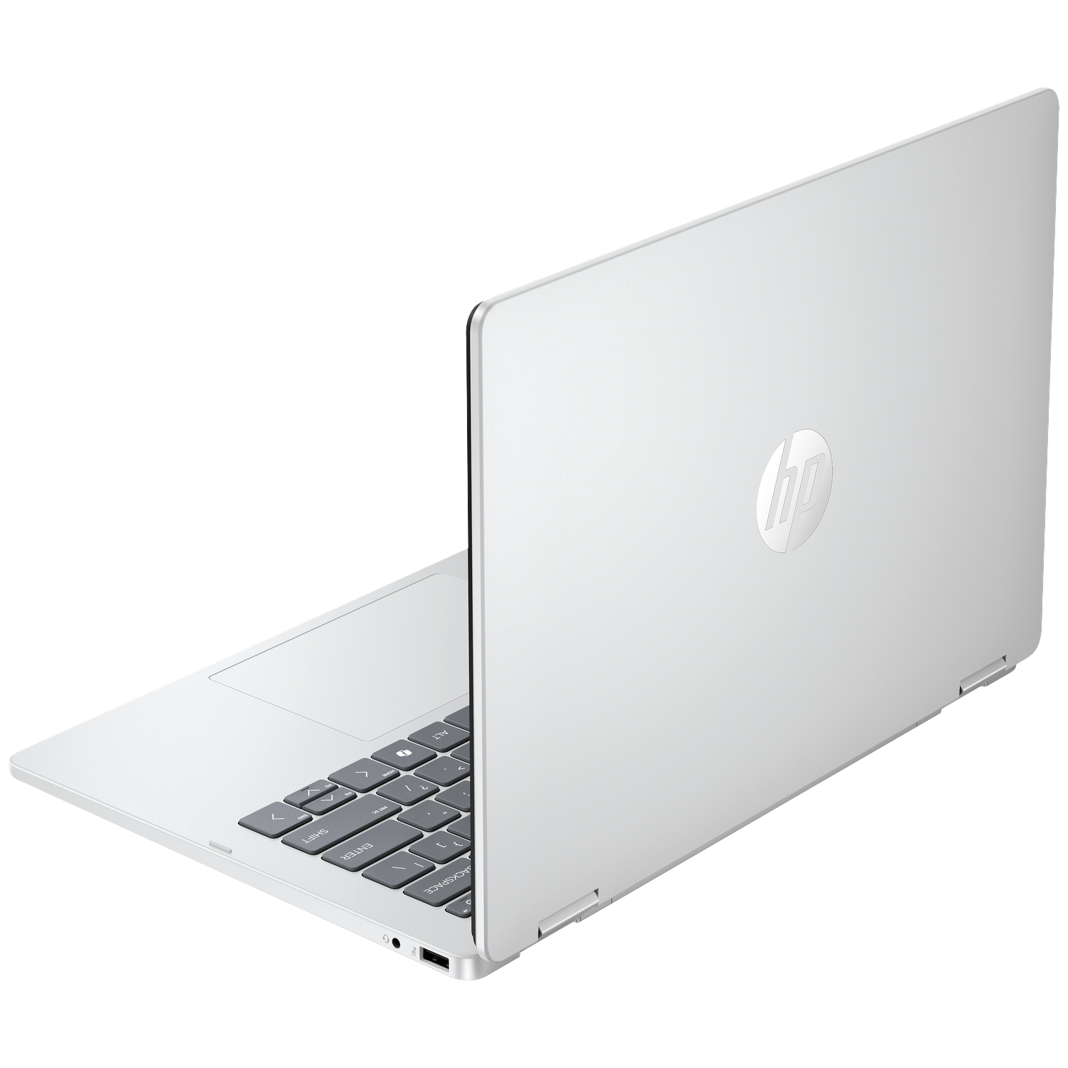 A silver HP laptop is open, focusing on the keyboard and the shiny logo on the lid.