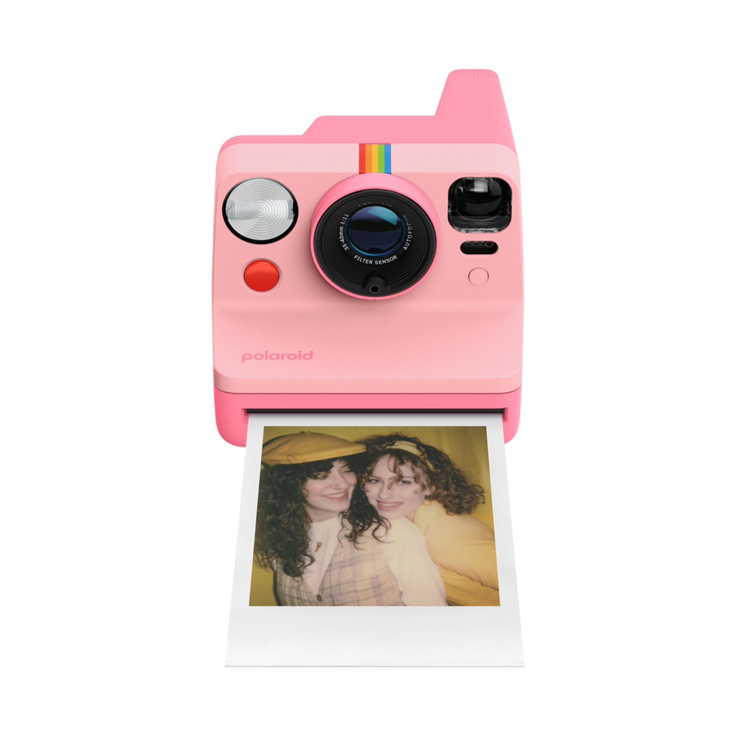 Una fotocamera Polaroid rosa con una foto di due donne e un cappello giallo.