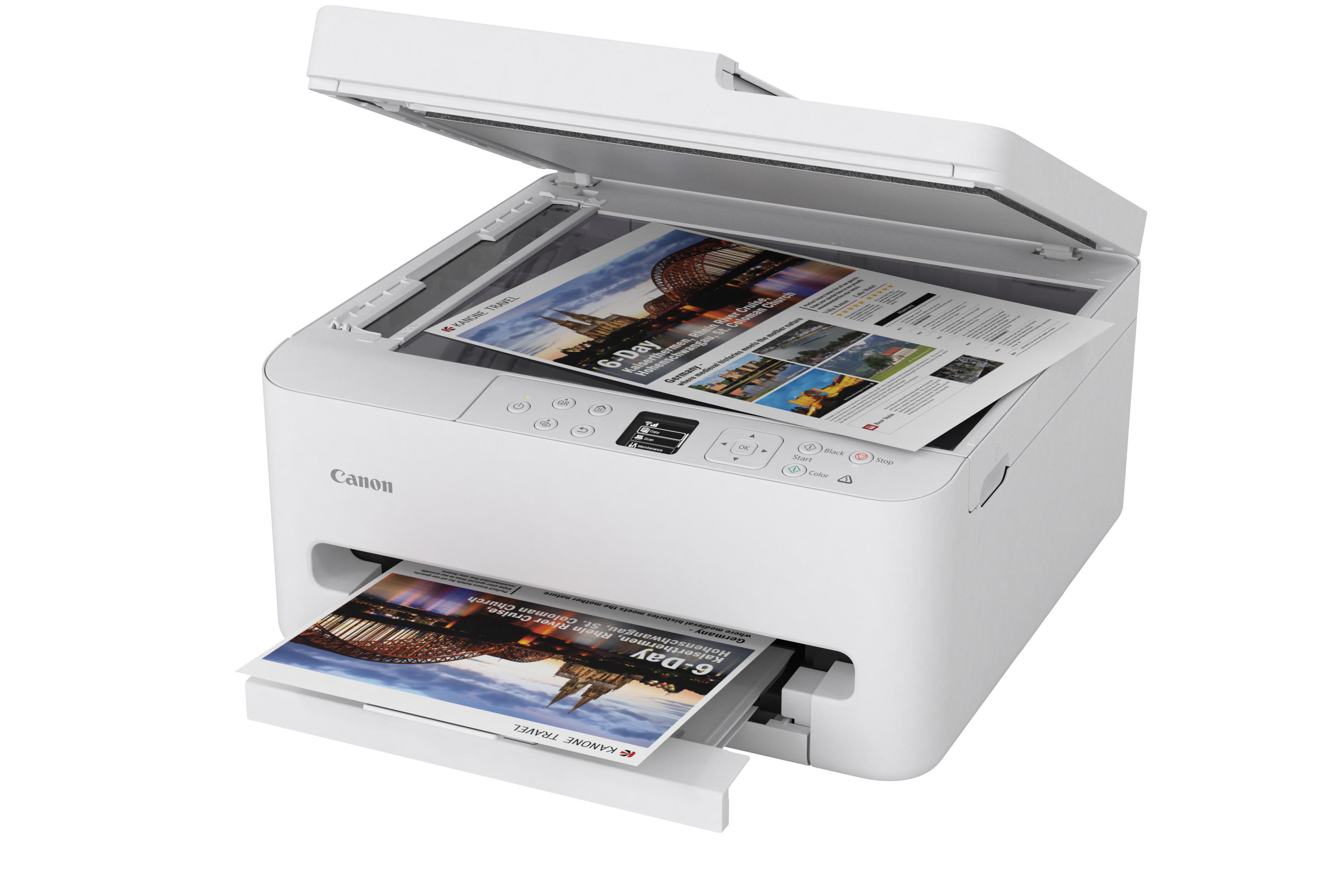 Ein weißer Canon-Drucker mit offenem Deckel, bedrucktes Papier liegt darin.