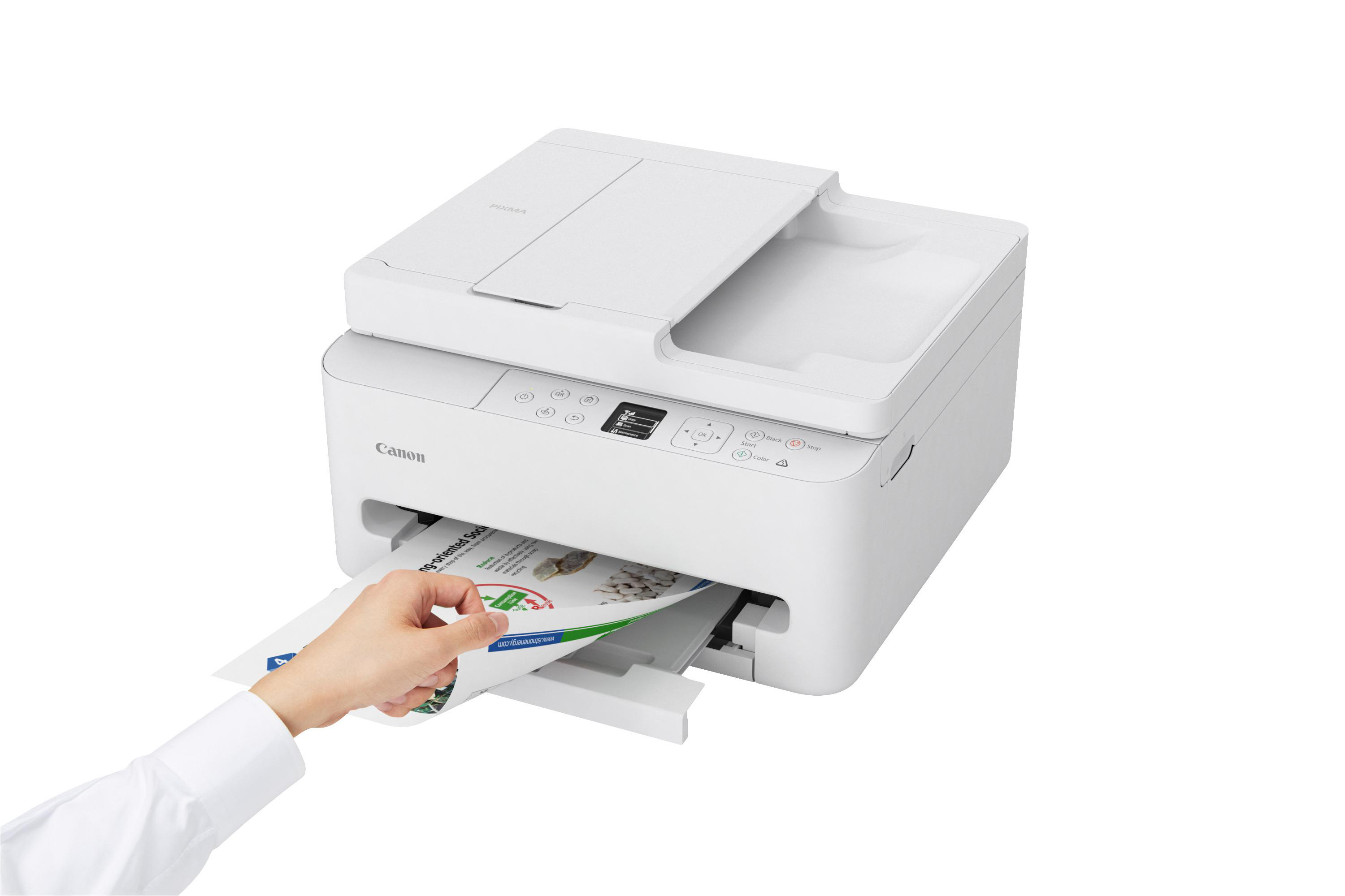 Weiße Canon Pixma Drucker mit einem Blatt Papier, das von einer Hand eingeführt wird.