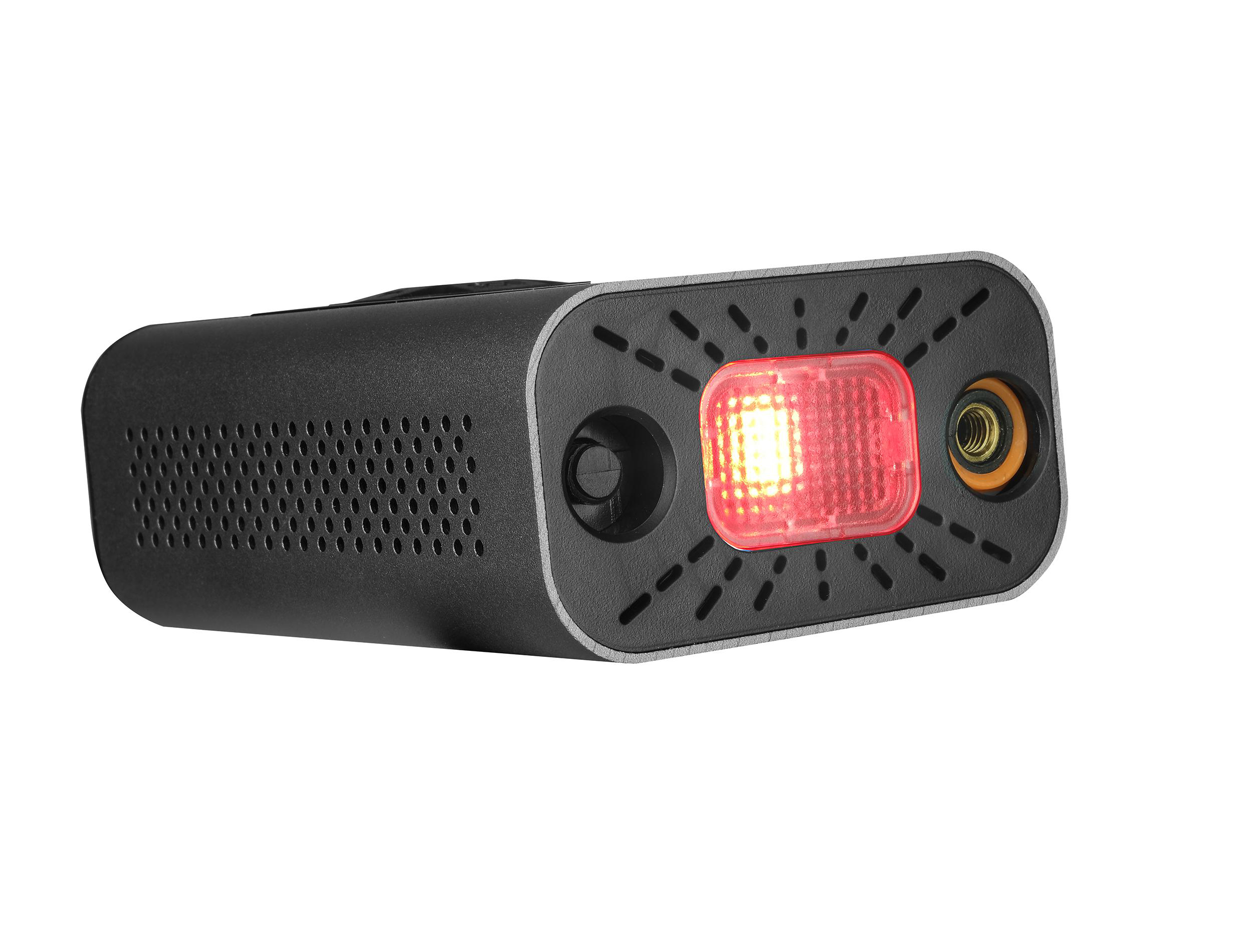 Kompakte schwarze Lampe mit rotem Licht und Lüftungsschlitzen.