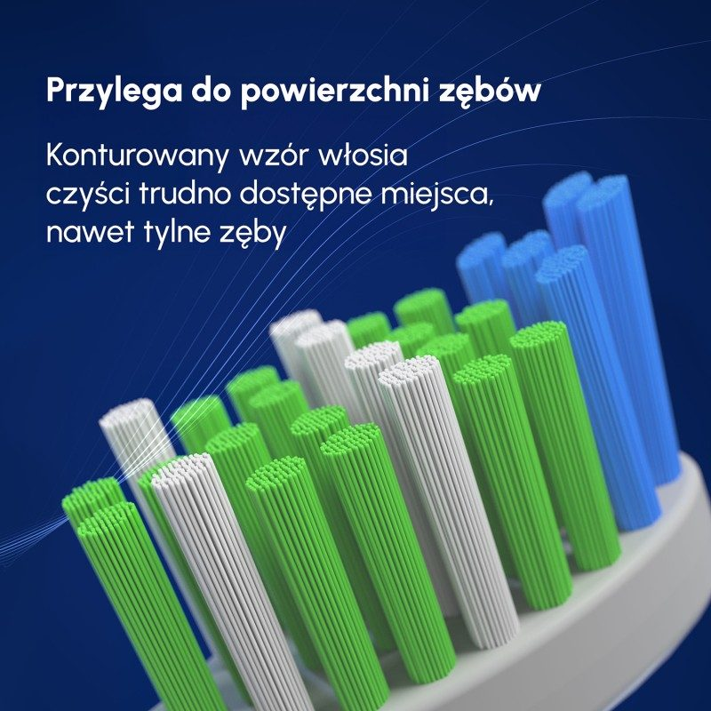 Zbliżenie na białe, zielone i niebieskie włosie szczoteczki do zębów.