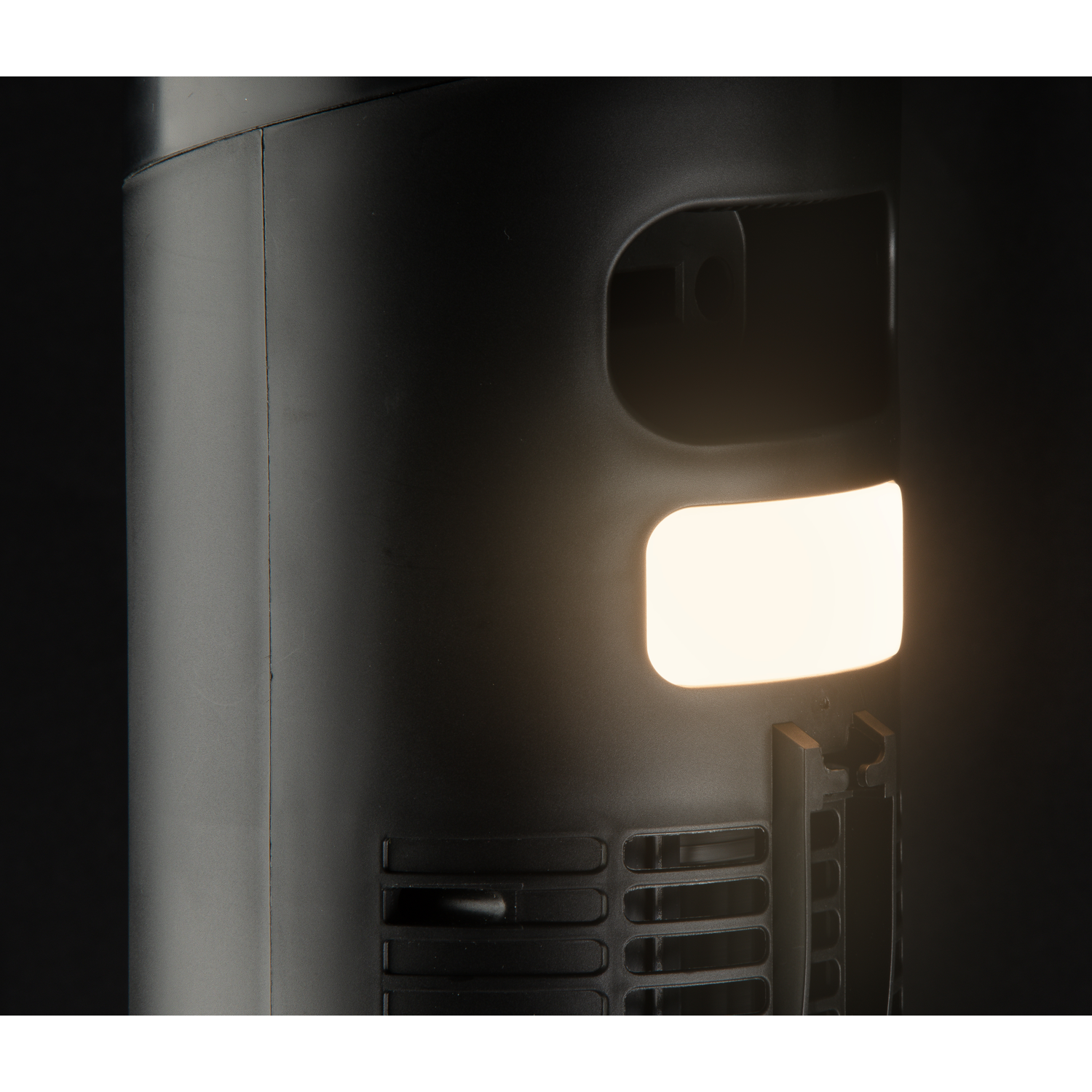 Close-up of a black cylinder with a glowing rectangular opening.