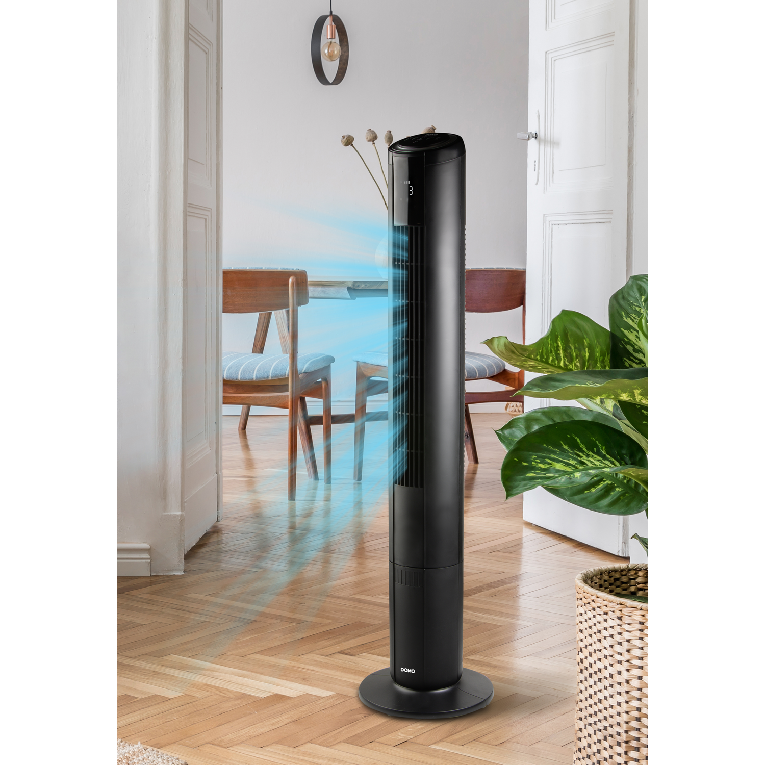 Black tower fan with airflow in a stylish living room.