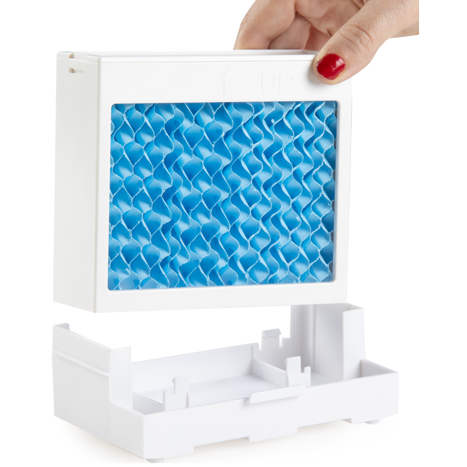 A hand holds a white filter with a blue honeycomb pattern.