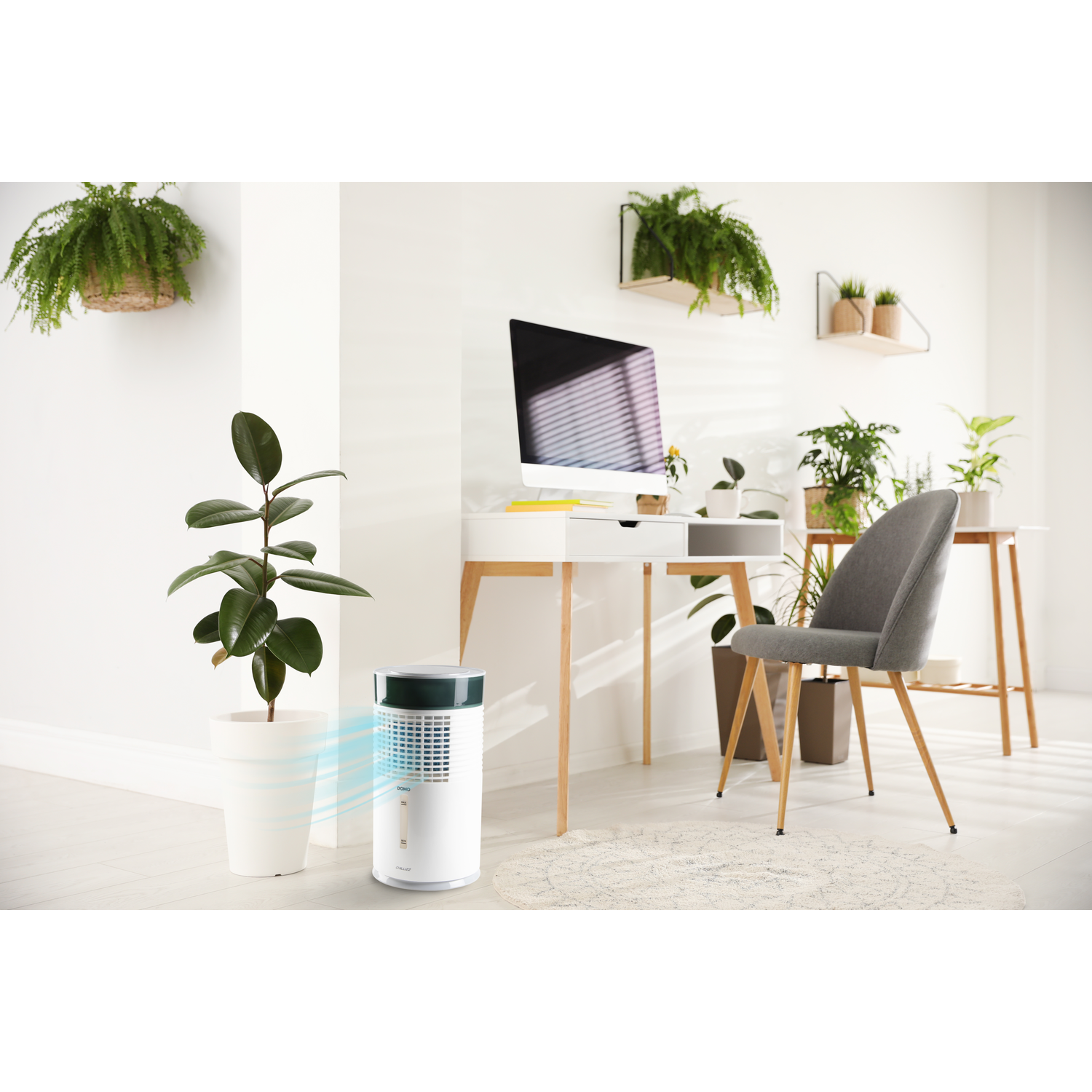 A white air cooler with blue mist sits next to a potted plant.