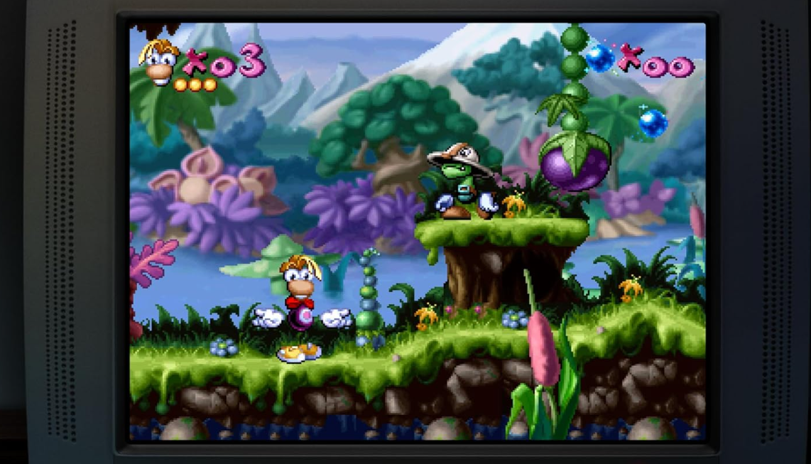 Rayman-Spielcharakter steht auf einer grünen Plattform. Bunte Landschaft.