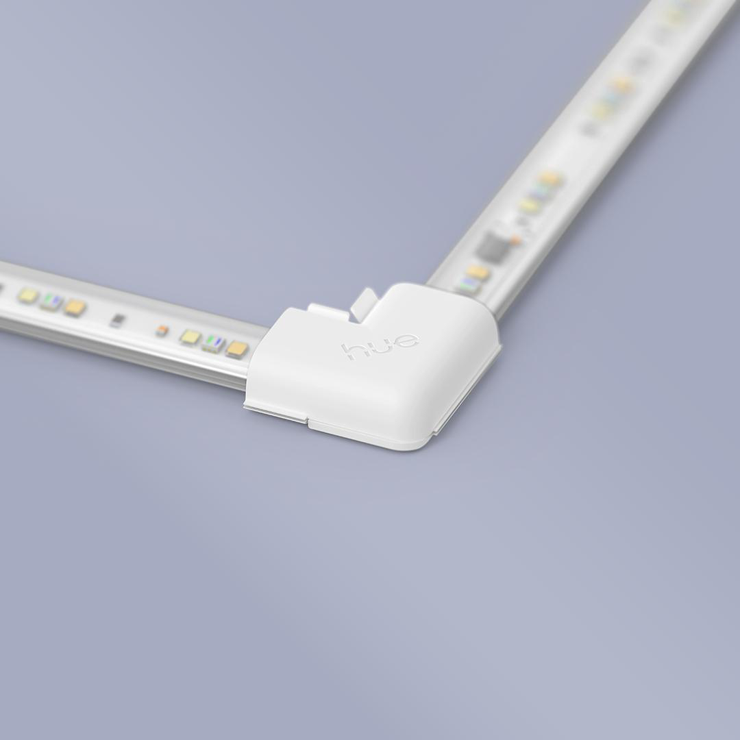 Weiße Hue LED-Streifen mit Eckverbinder auf grauem Hintergrund.
