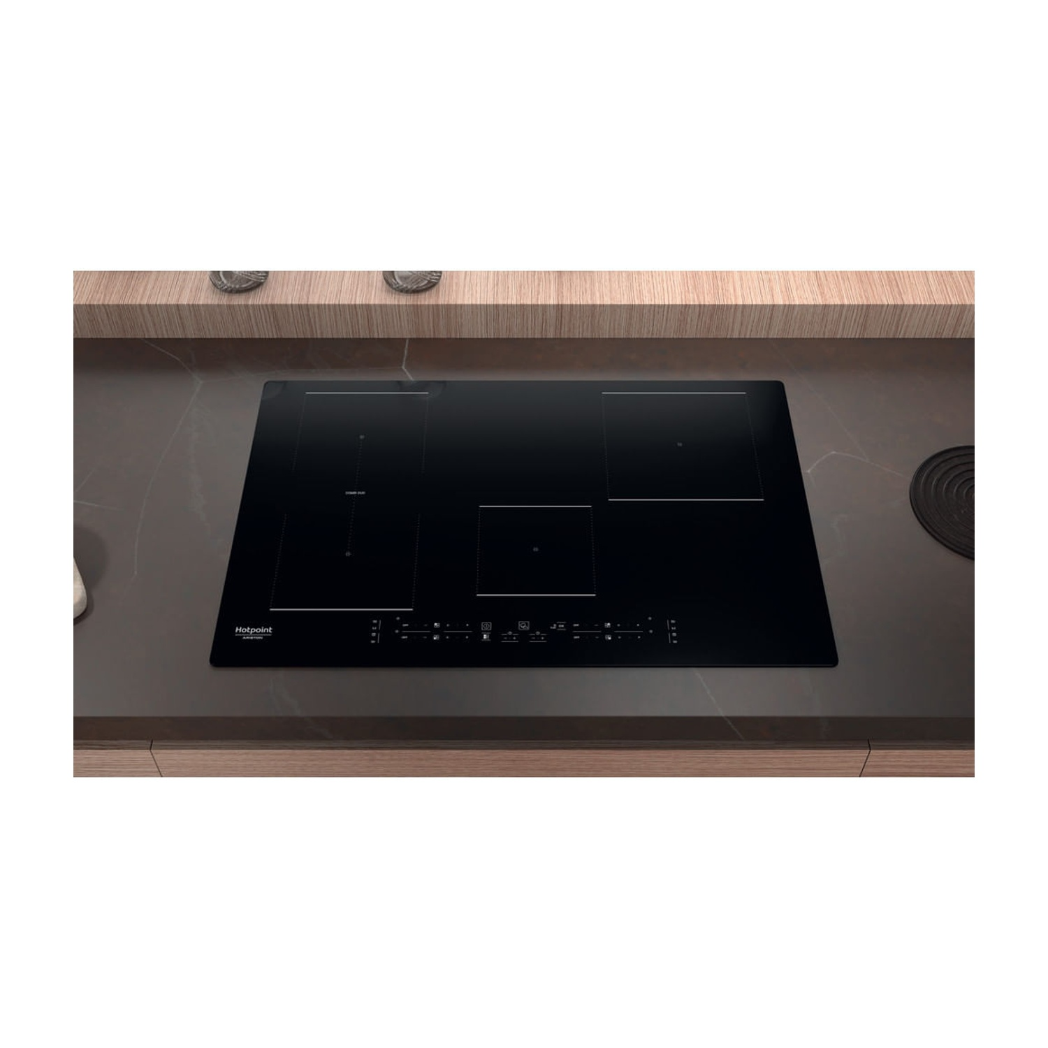 Un piano cottura a induzione nero con pannello di controllo touch screen su un piano di lavoro scuro.