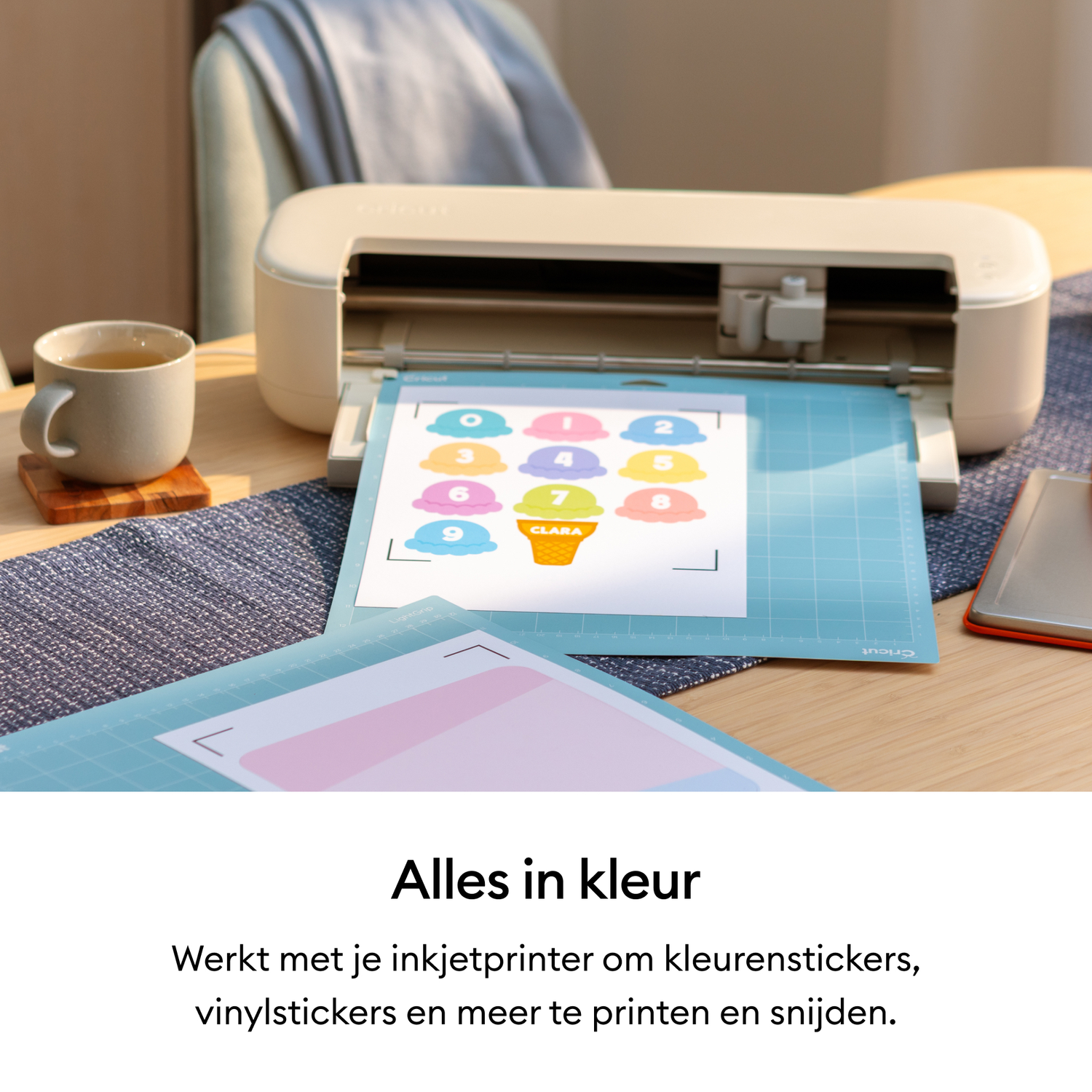 A cutting machine cuts out colorful stickers with ice cream cone designs.