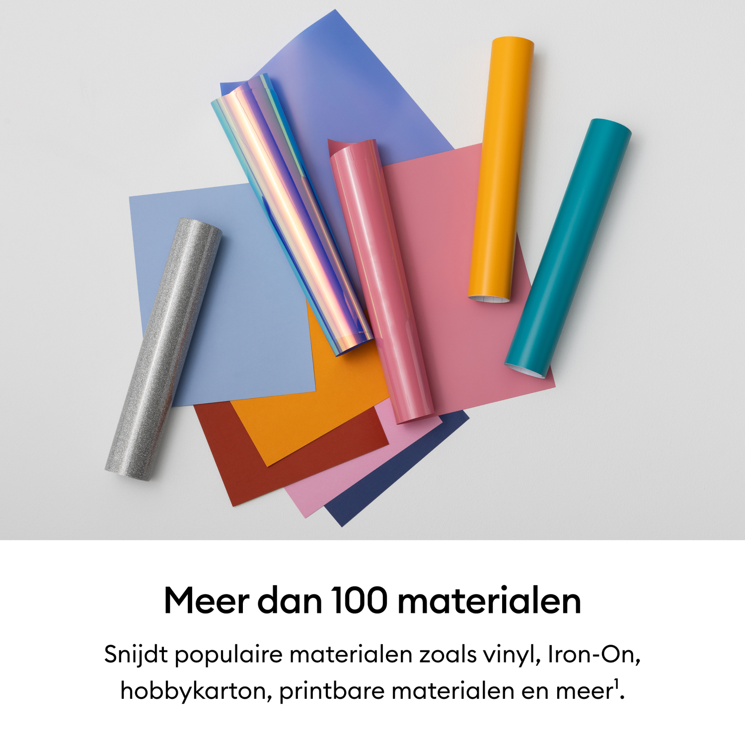 Rolls of vinyl in various colors lie on colorful paper sheets.