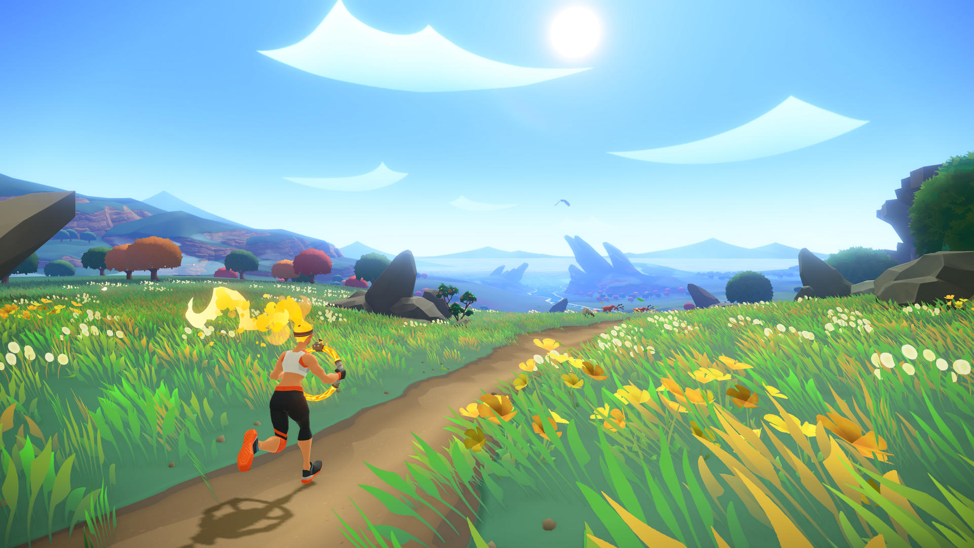 Kobieta biegnie przez kwieciste pole. W tle góry i słońce.