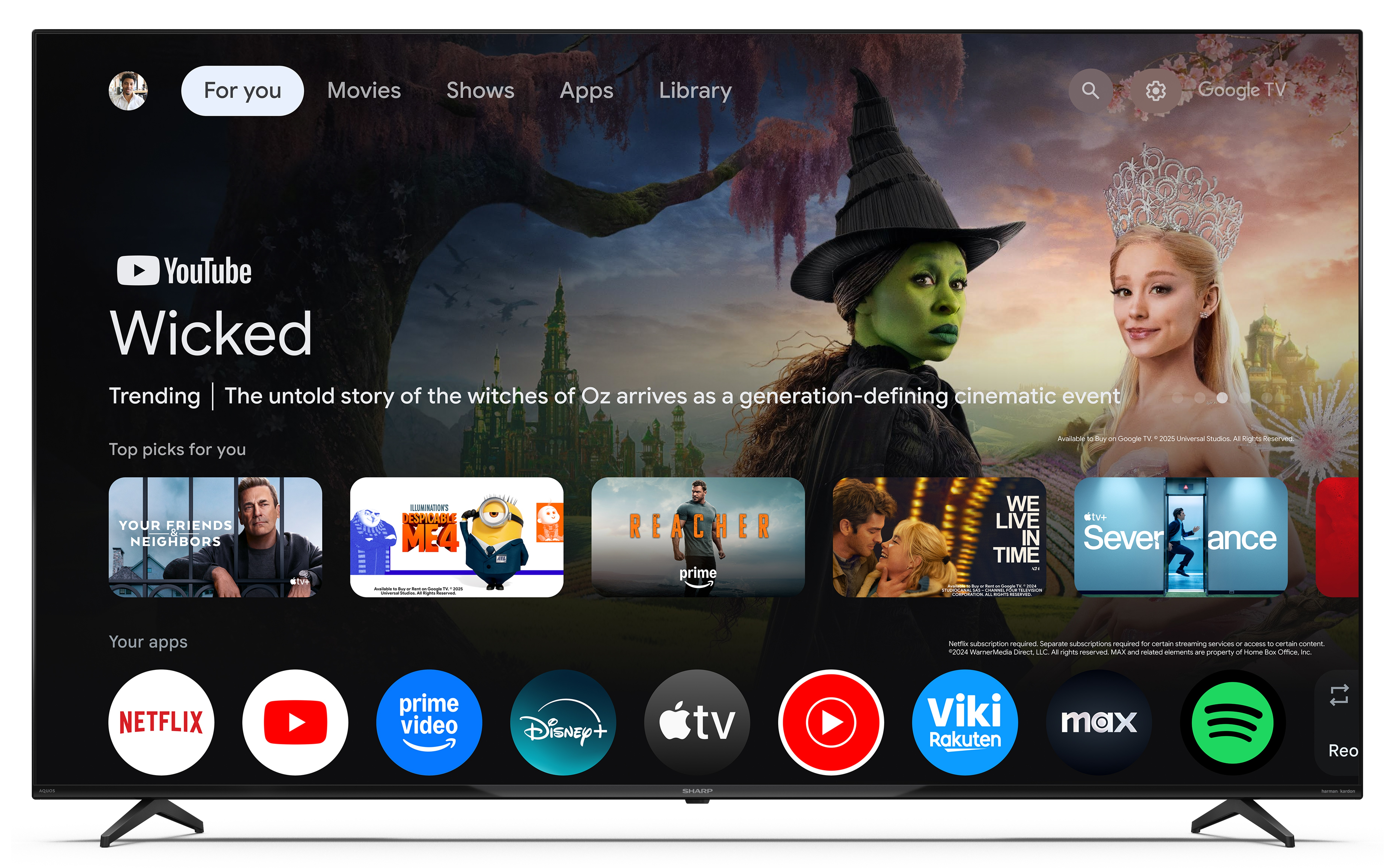 Ekran główny Google TV z propozycjami filmu "Wicked" i ikonami aplikacji.