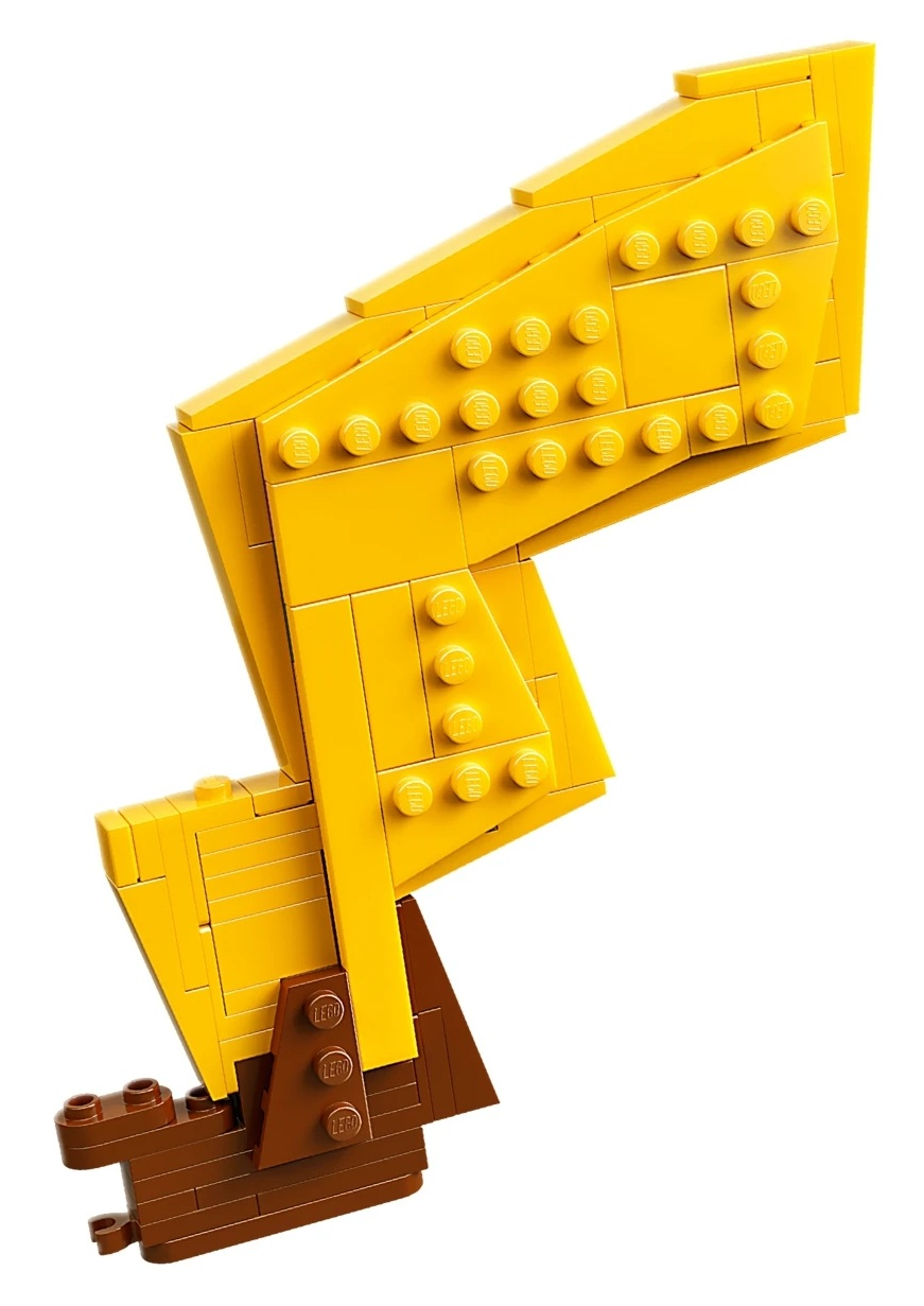 Żółta konstrukcja Lego z brązowymi elementami Lego na dole.